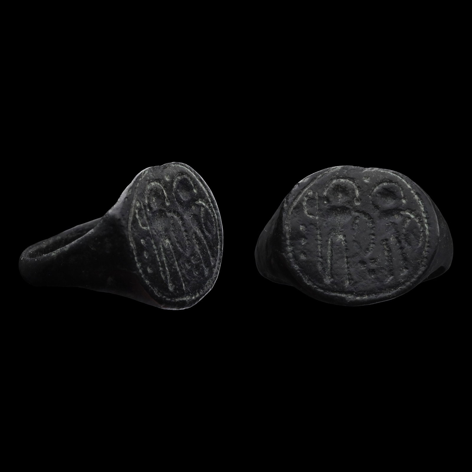 Byzantine Bronze Ring with Warrior Saints: Circa 6th-8th century A.D. D-section hoop and a large oval bezel with two nimbate warriors holding shields and a spear. 5.83 grams, 22.35 mm overall, 18.92 mm internal diameter (approximate size Briti