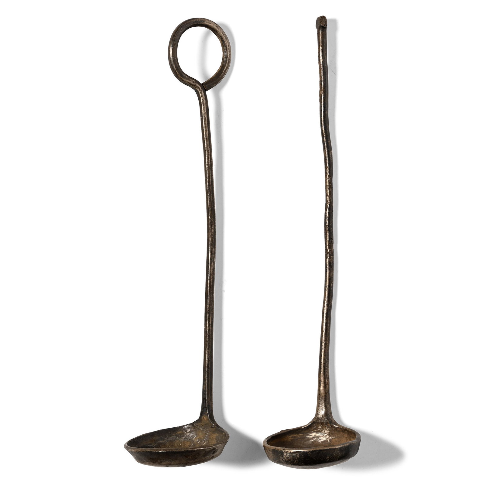 Byzantine Silver Priest's Ladle Pair: Circa 10th-13th century A.D. Each with a shallow discoid bowl and flared rim, round-section shank; one with an integral suspension ring. 58.3 grams total, 16.2-16.5 cm (6 3/8 - 6 1/2 in.). [2] Ex prop