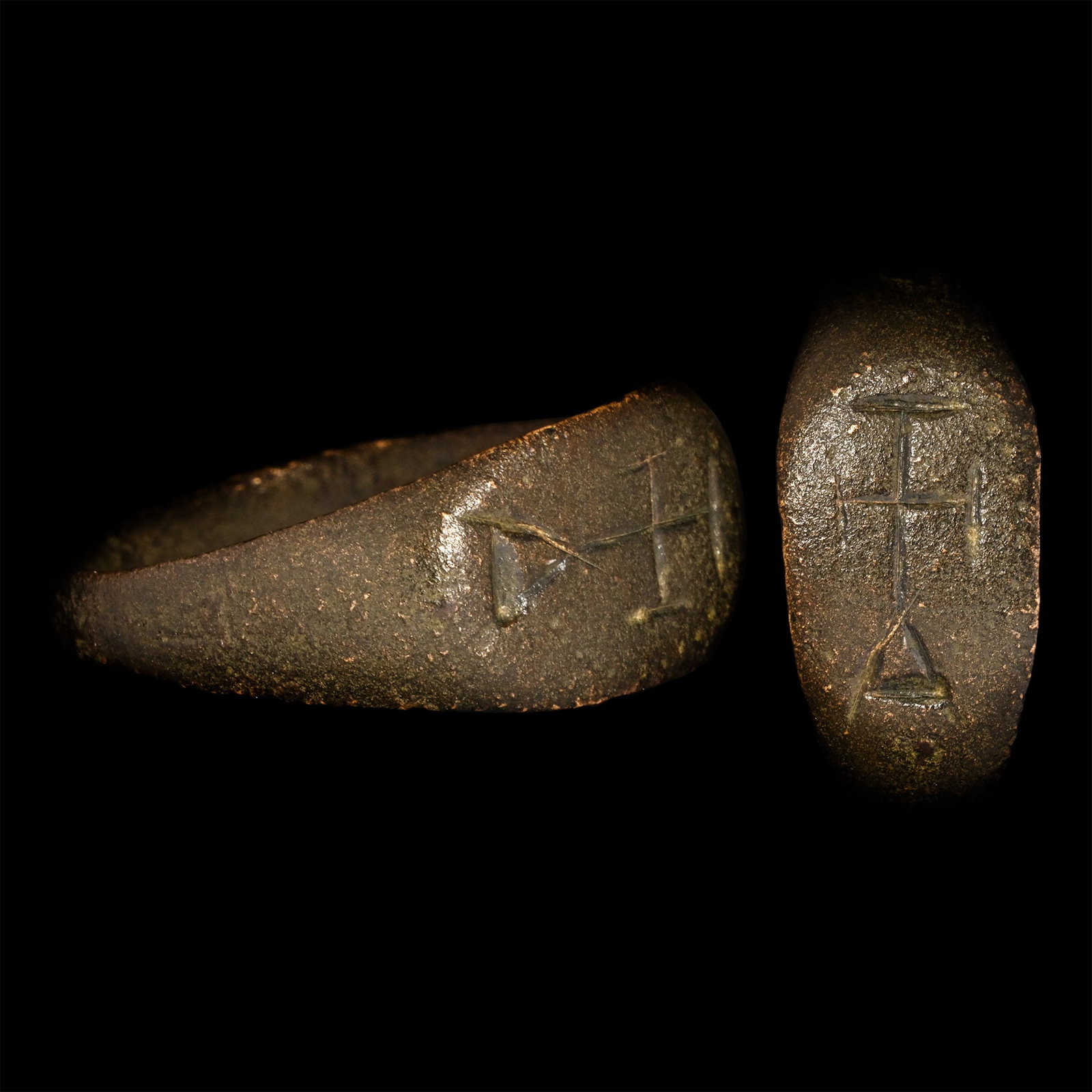 Byzantine Bronze Ring with Cross: 6th-8th century A.D. Hoop expanding towards the shoulders, oval bezel with a cross on a triangular base. 3.65 grams, 22.69 mm overall, 20.44 mm internal diameter (approximate size British U, USA 10, E