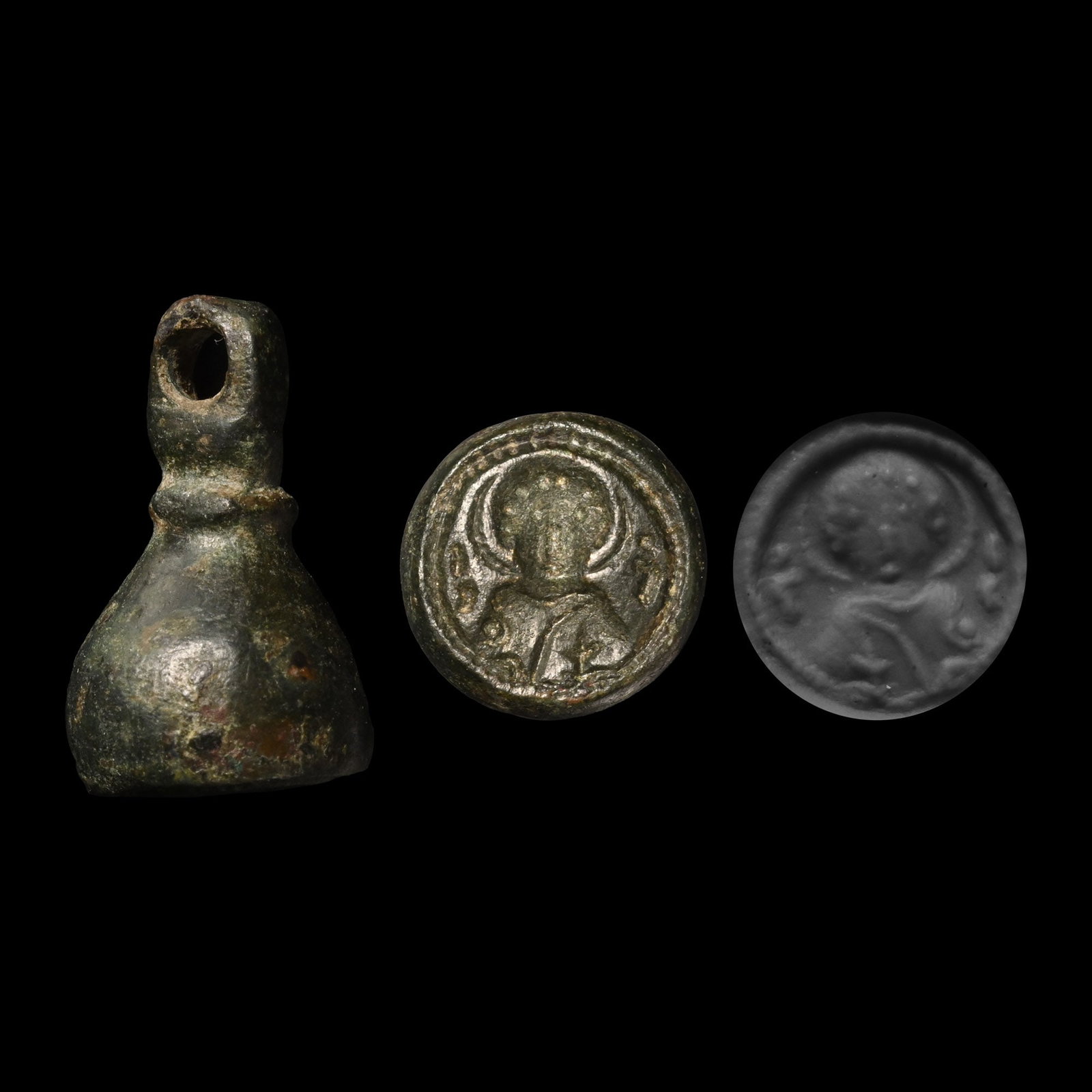 Byzantine Bronze Seal with Saint: 8th-10th century A.D. Collared loop above, underside with facing bust of a nimbate saint holding a cross. 6.34 grams, 18 mm (3/4 in.). [No Reserve] Ex German art market, 2000s. Acquired from an EU col