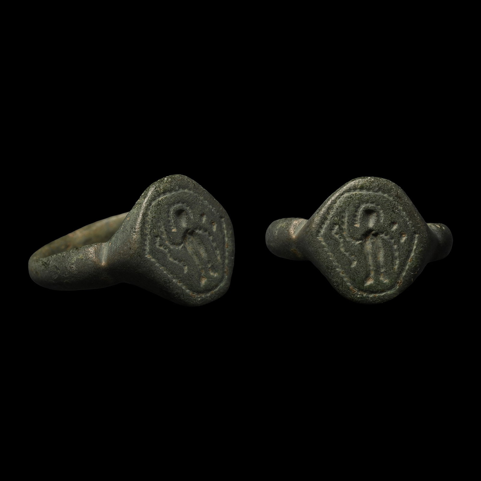 Byzantine Bronze Ring with Warrior Saint: 12th-13th century A.D. D-section hoop with keeled shoulders, polygonal bezel with a stylised nimbate figure. Cf. for the type Crajovan, B., ?Inele medievale cu ?i f?r? chaton descoperite pe teritoriul