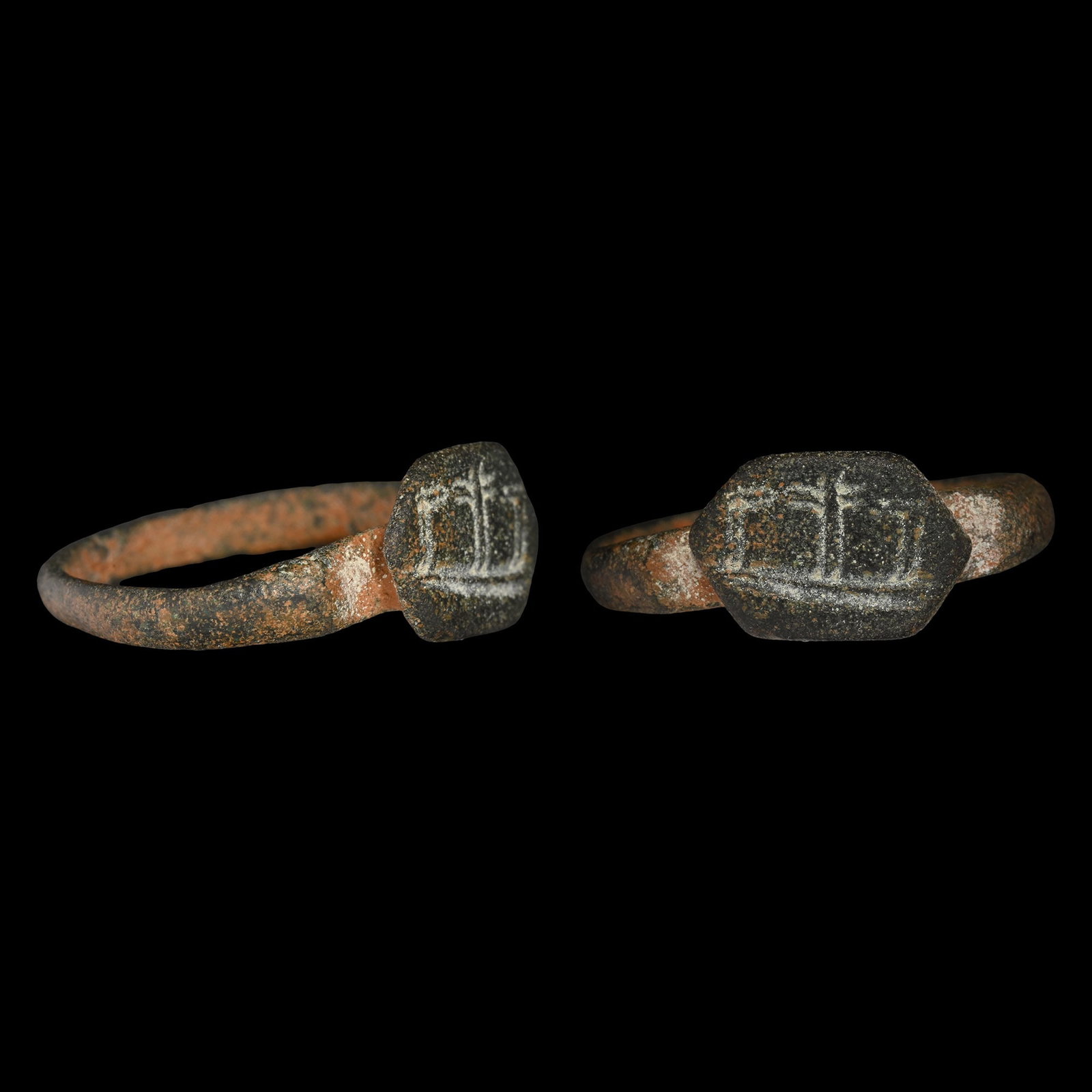 Byzantine Bronze Ring with Three Crosses of the Crucifixion: Circa 5th century A.D. Comprising a D-section hoop and a hexagonal bezel with three crosses on a baseline. 4.23 grams, 23.24 mm overall, 19.00 x 17.01 mm internal diameter (approximate size British N 