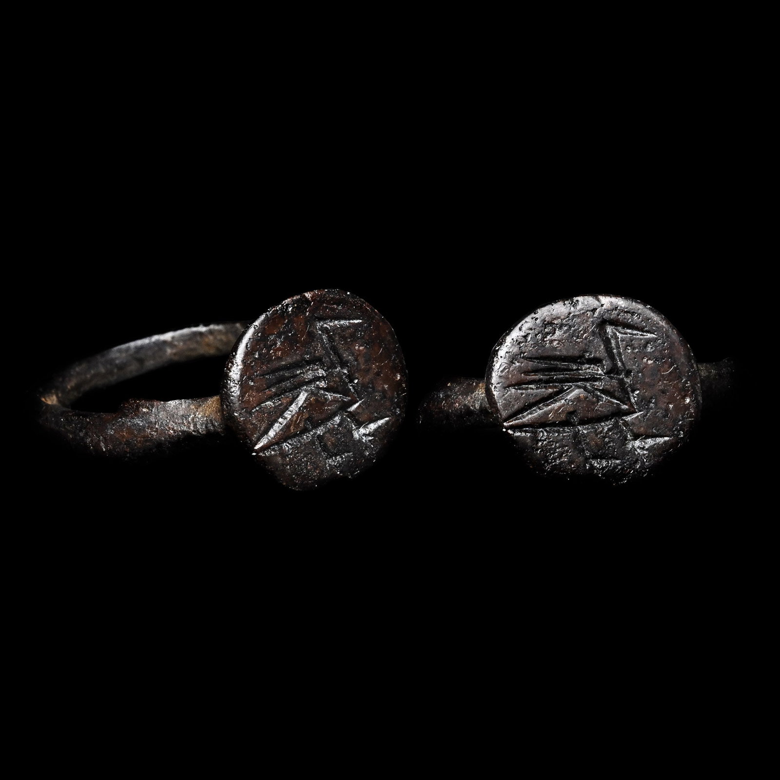 Large Byzantine Bronze Ring with Bird: 6th-8th century A.D. Comprising a slender large hoop and a discoid bezel with a stylised standing bird. 2.34 grams, 23.12 mm overall, 18.28 x 20.50 mm internal diameter (approximate size British Q, US