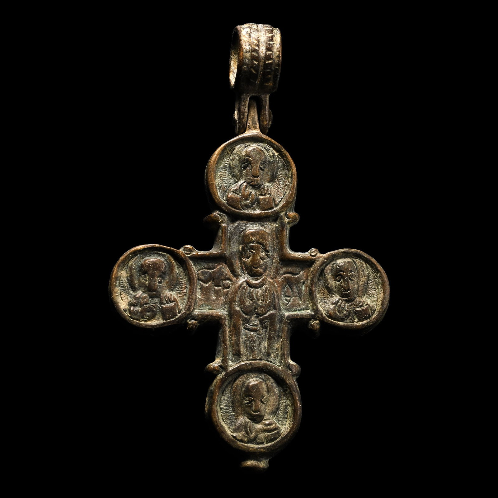 Large Byzantine Bronze Cross Pendant with Christ and Saints: Circa 10th-12th century A.D. Obverse: central facing nimbate figure of Mary with 'MHP ?V' legend, facing nimbate bust in each of the roundels; reverse with cruciform void and pellets; hinged loop with