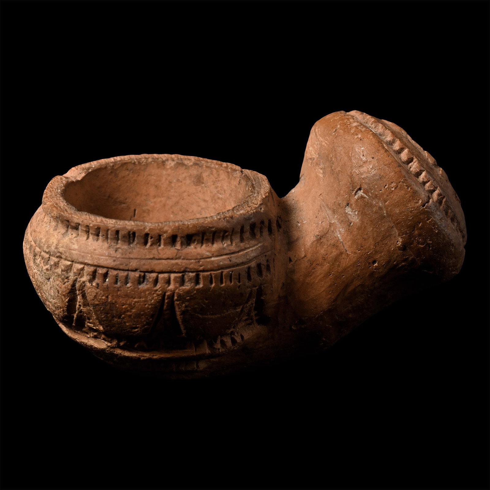 Western Asiatic Ceramic Tobacco Pipe Bowl: 17th-18th century A.D. Bowl with carinated shoulder, impressed rouletting, angled joint with bulbous mouth. 24.7 grams, 53 mm (2 1/8 in.). [No Reserve] From the private collection of Mr Brian Edwards,