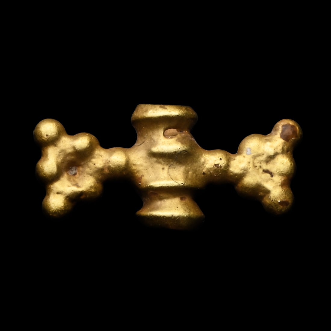 Western Asiatic Gold Bead Pendant: 1st millennium B.C. Featuring a tubular, ridged centre bead with triangular granulated projection above and below. 0.48 grams, 11 mm (3/8 in.). From a late Japanese gentleman's collection, formed 1970