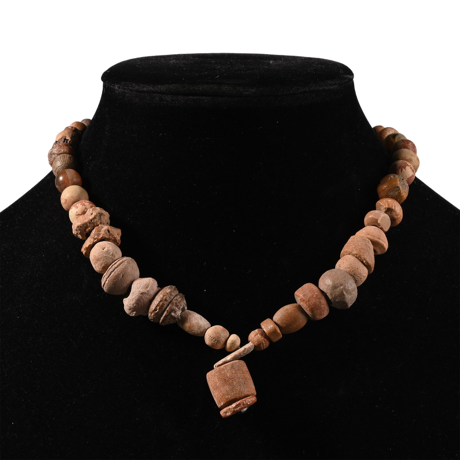 Western Asiatic Ceramic and Other Bead Necklace String: 1st millennium B.C. and later. Graduated group of mainly oblate beads with a large cylindrical feature bead; restrung. 44.5 grams, 37 cm (14 5/8 in.). [No Reserve] Acquired in the 1990s. Ex London, UK