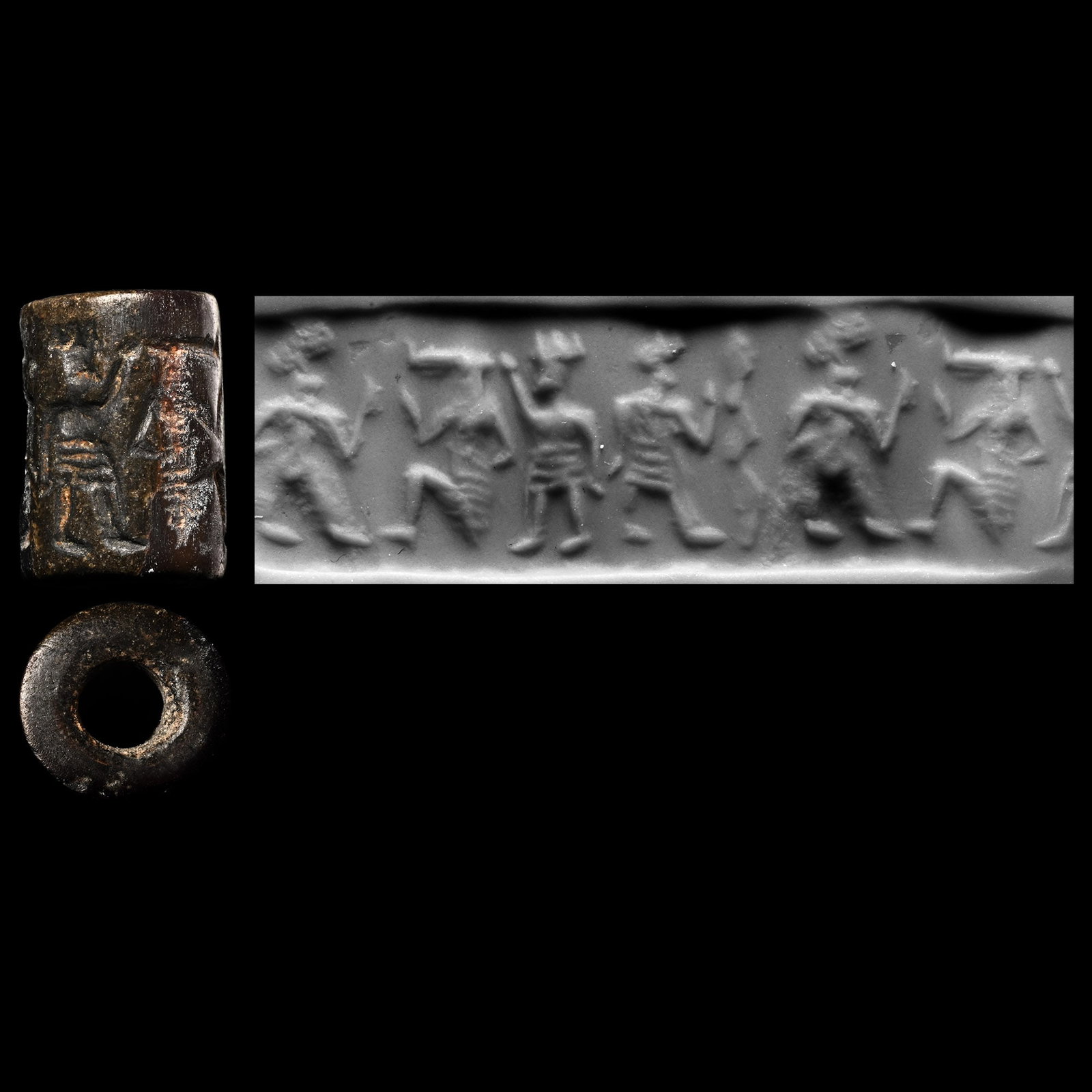 Western Asiatic Grey Stone Cylinder Seal with Figural Scene: 750-650 B.C. Frieze depicting a kneeling figure in segmented kilt facing a figure with one arm raised standing back-to-back with a similar figure in a flounced knee-length garment; supplied with a mus