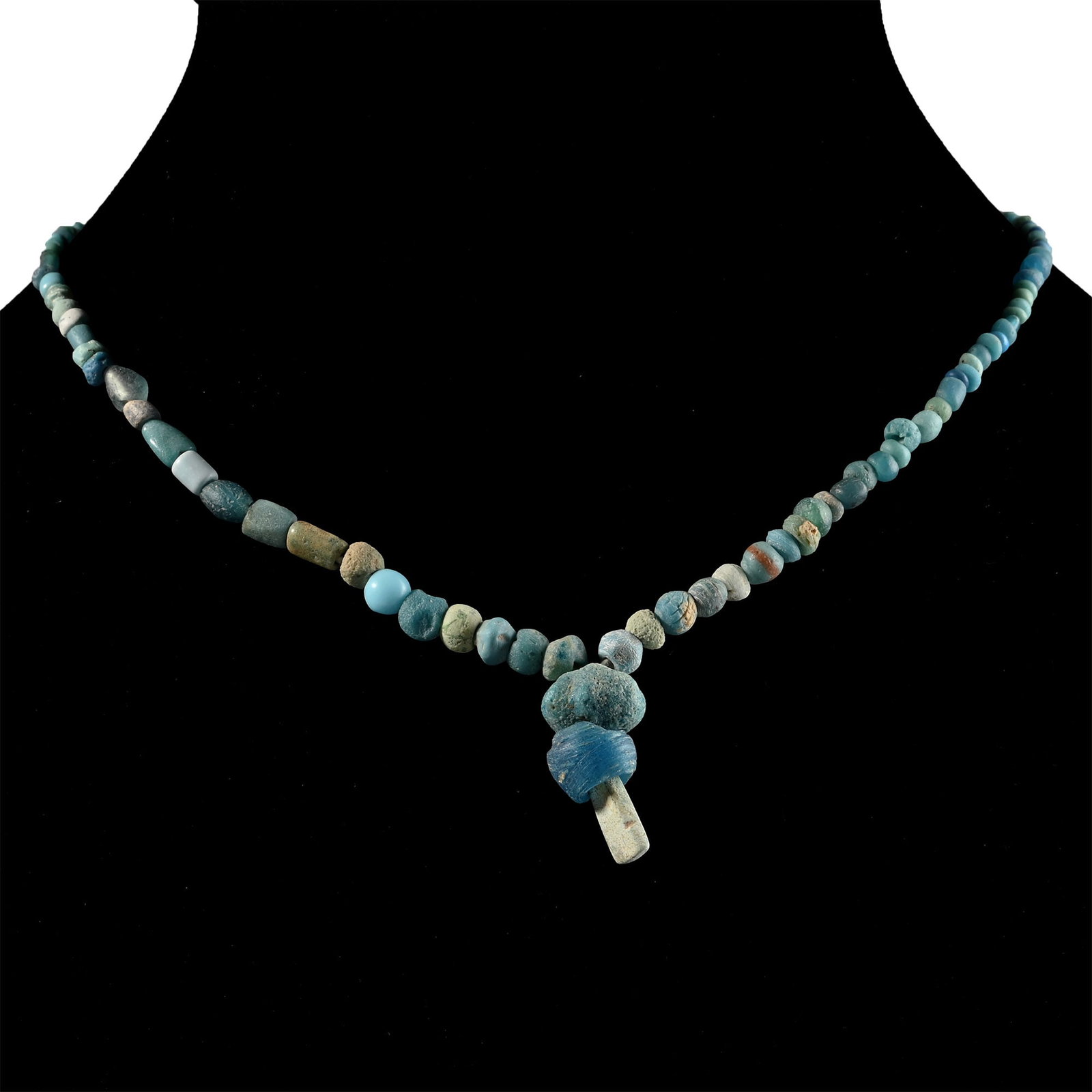Achaemenid Turquoise Glass and Other Bead Necklace String: Mid 1st millennium B.C. and later. Composed mainly of graduated oblate beads with larger beads as the central feature, restrung. 10.5 grams, 38 cm (15 in.). [No Reserve] Acquired in the 1990s. Ex Lond