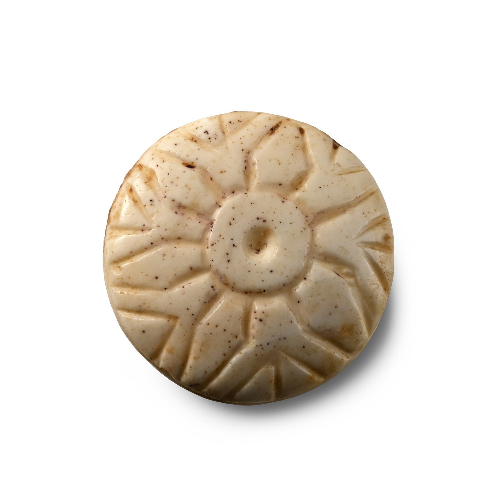 Western Asiatic Pommel Cap with Floral Design: 1st millennium B.C. Carved in marble or bone with broad domed upper face, barrel-shaped shank with a horizontal incised band, pieced laterally and with hollow underside to the shank; upper face with l