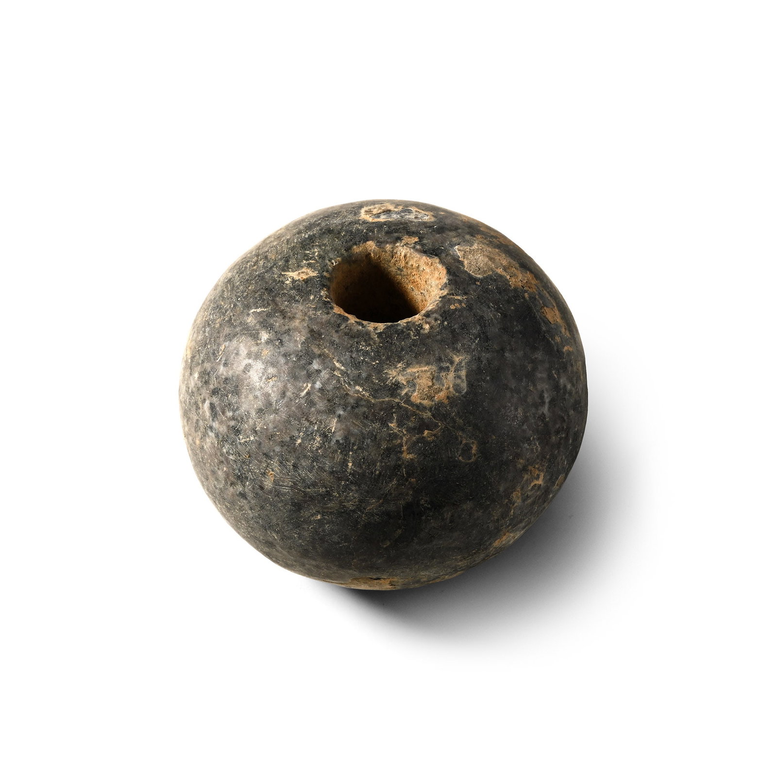 Western Asiatic Polished Stone Macehead: 3rd-2nd millennium B.C. Doughnut-shaped body and a round socket. 431 grams, 73 mm (2 7/8 in.). From the collection of a London, UK, gentleman, 1990s. TimeLine Auctions follows a rigorous vetting proce