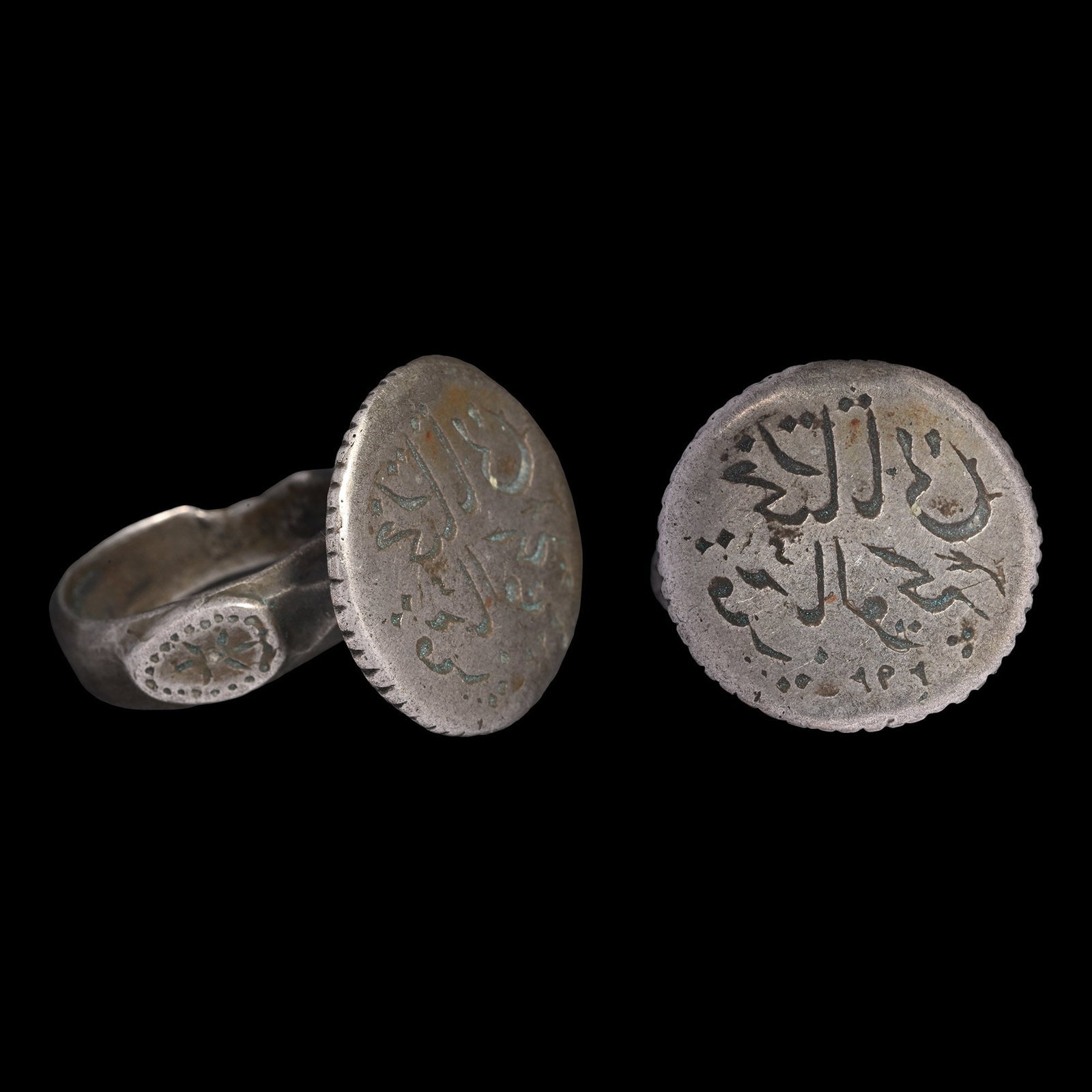 Large Western Asiatic Silver Ring with Calligraphic Inscription: Circa 18th-19th century A.D. The hoop with three raised bosses, a tall discoid bezel with a two-line inscription. 15.89 grams, 31.02 mm overall, 18.02 x 19.06 mm internal diameter (approximate size Br