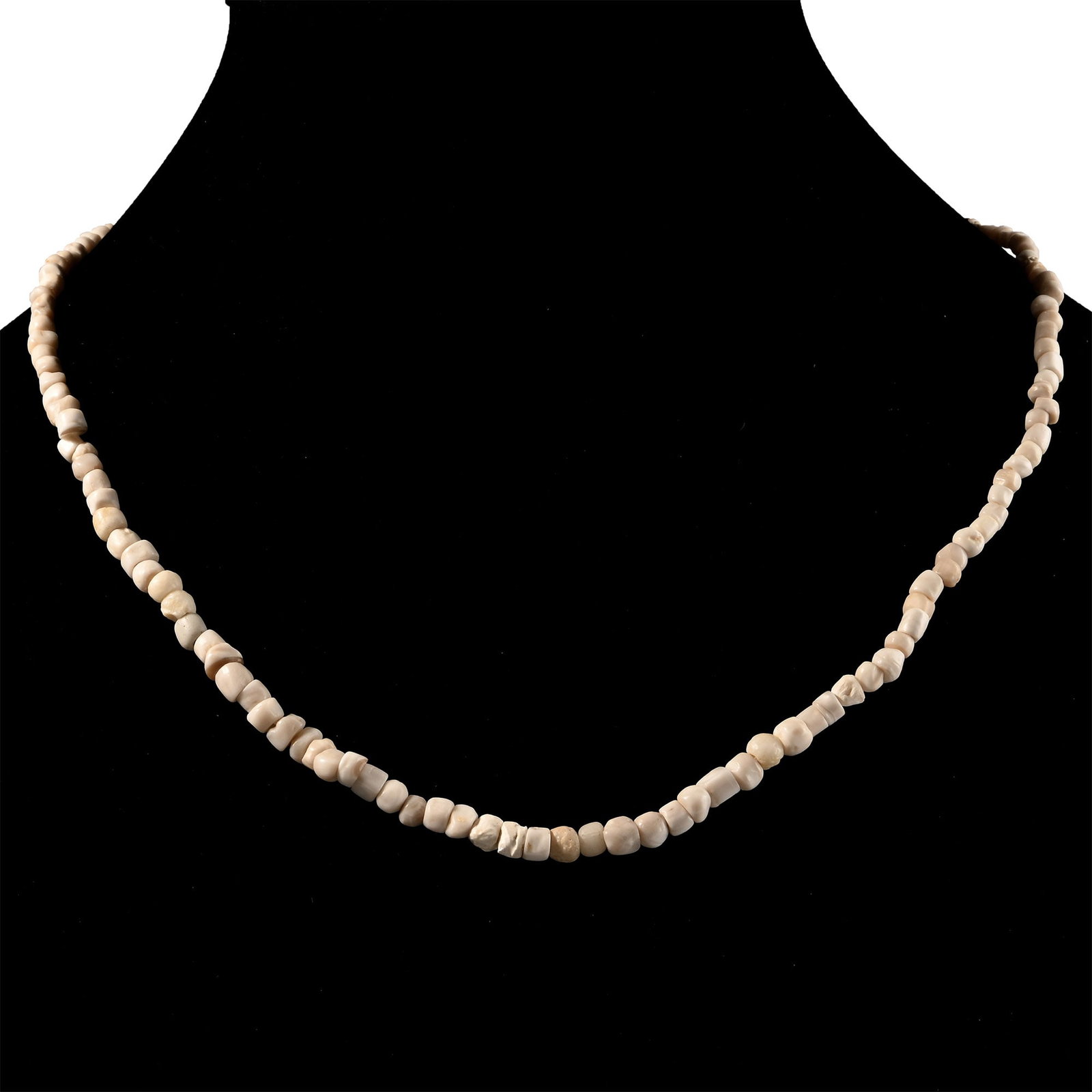 Western Asiatic Cream Glass and Other Bead Necklace String: 1st millennium B.C. and later. Composed mainly of oblate beads, restrung. 14.2 grams, 40.5 cm (16 in.). [No Reserve] Acquired in the 1990s. Ex London, UK, collection. TimeLine Auctions follows a rigor