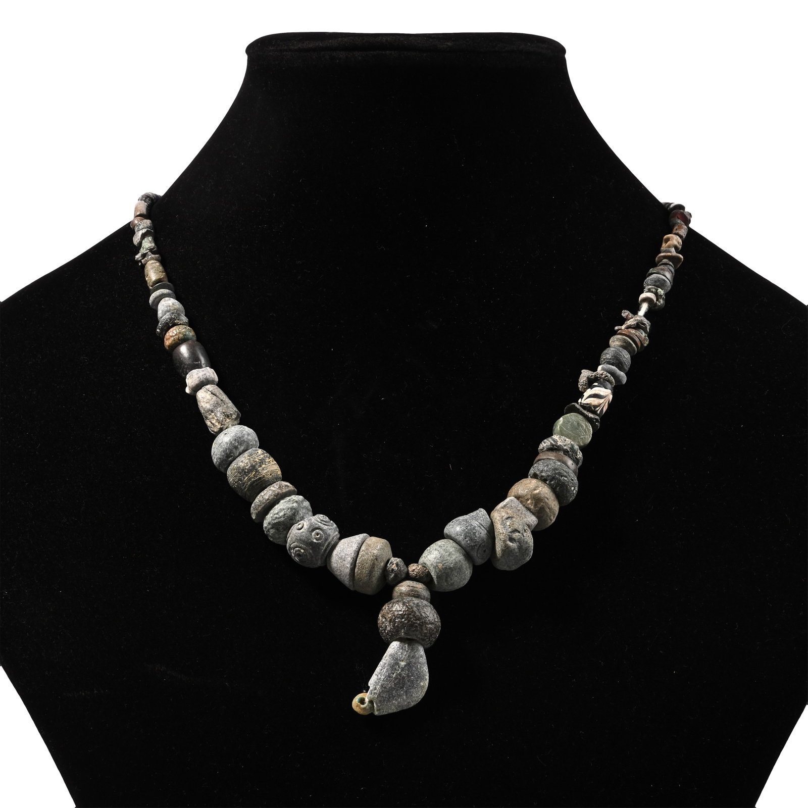 Western Asiatic Stone and Other Bead Necklace String: 1st millennium B.C. and later. Composed of mixed graduated beads with an elbow bead as the central feature, restrung. 62 grams, 37.2 cm (14 5/8 in.). [No Reserve] Ex Ancient Art Shop, Windsor, UK, 199