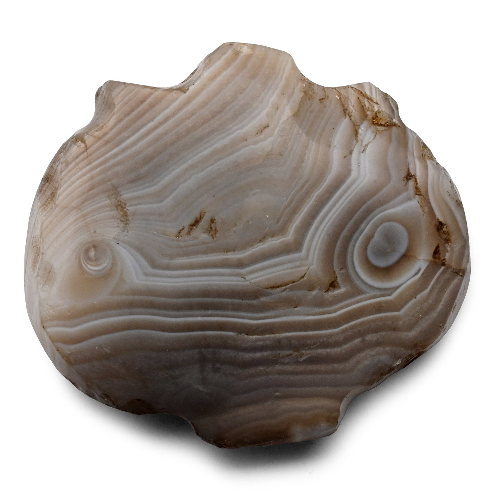 Bactrian Banded Agate Talismanic Pendant: 2nd millennium B.C. Discoid pendant with slightly domed faces carved from banded agate, rectangular tab above and below, the upper one pierced for suspension. 7.95 grams, 30 mm (1 1/8 in.). Ex French 