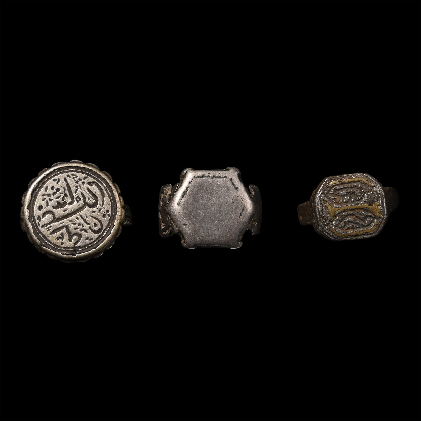Western Asiatic Silver-Coloured Metal Ring Group: Circa 12th-18th century A.D. A mixed group of rings from the Seljuk and Ottoman periods, comprising three rings: one with a calligraphic inscription, one with a hexagonal bezel with remains of niello,