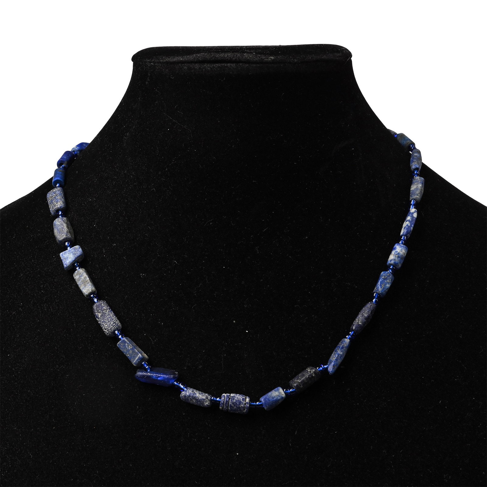 Western Asiatic Style Lapis Lazuli Bead Necklace String: 20th century A.D. Composed of irregular beads interspersed with small spherical glass beads; restrung. 18.7 grams, 40.5 cm (16 in.). [No Reserve] Ex London, UK, art market 1990s. TimeLine Auctions fol