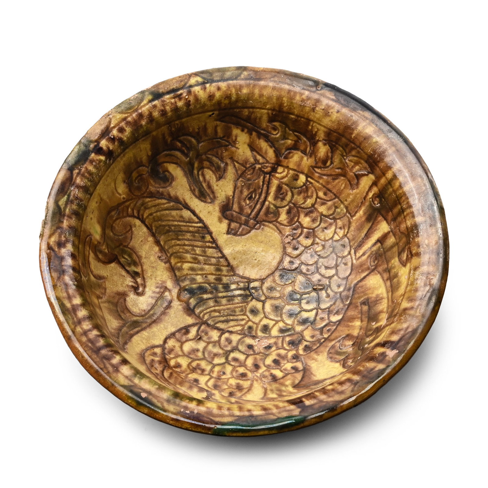 Large Western Asiatic Style Ceramic Bowl with Mythical Beast: Late 20th-21st century A.D. Bell-shaped in profile with polychrome rim, incised advancing winged feline among fronds. 577 grams, 21.7 cm wide (8 1/2 in.). [No Reserve] Private collection, UK. TimeLine