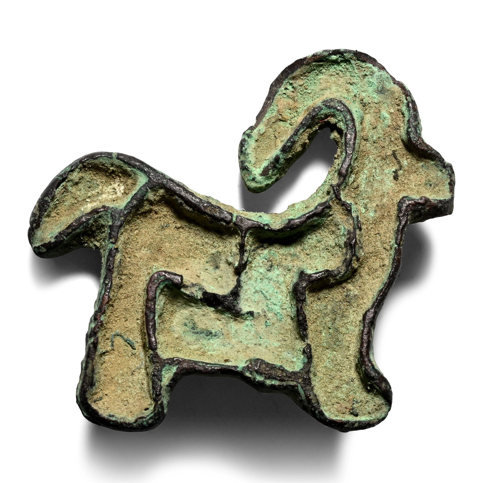 Western Asiatic Bronze Ibex Stamp Seal: 2nd millennium B.C. Compartmented seal shaped as a horned quadruped with a square body and curving horns, a loop on the reverse. 9.04 grams, 34 mm (1 3/ 8 in.). Ex the private collection of the late M