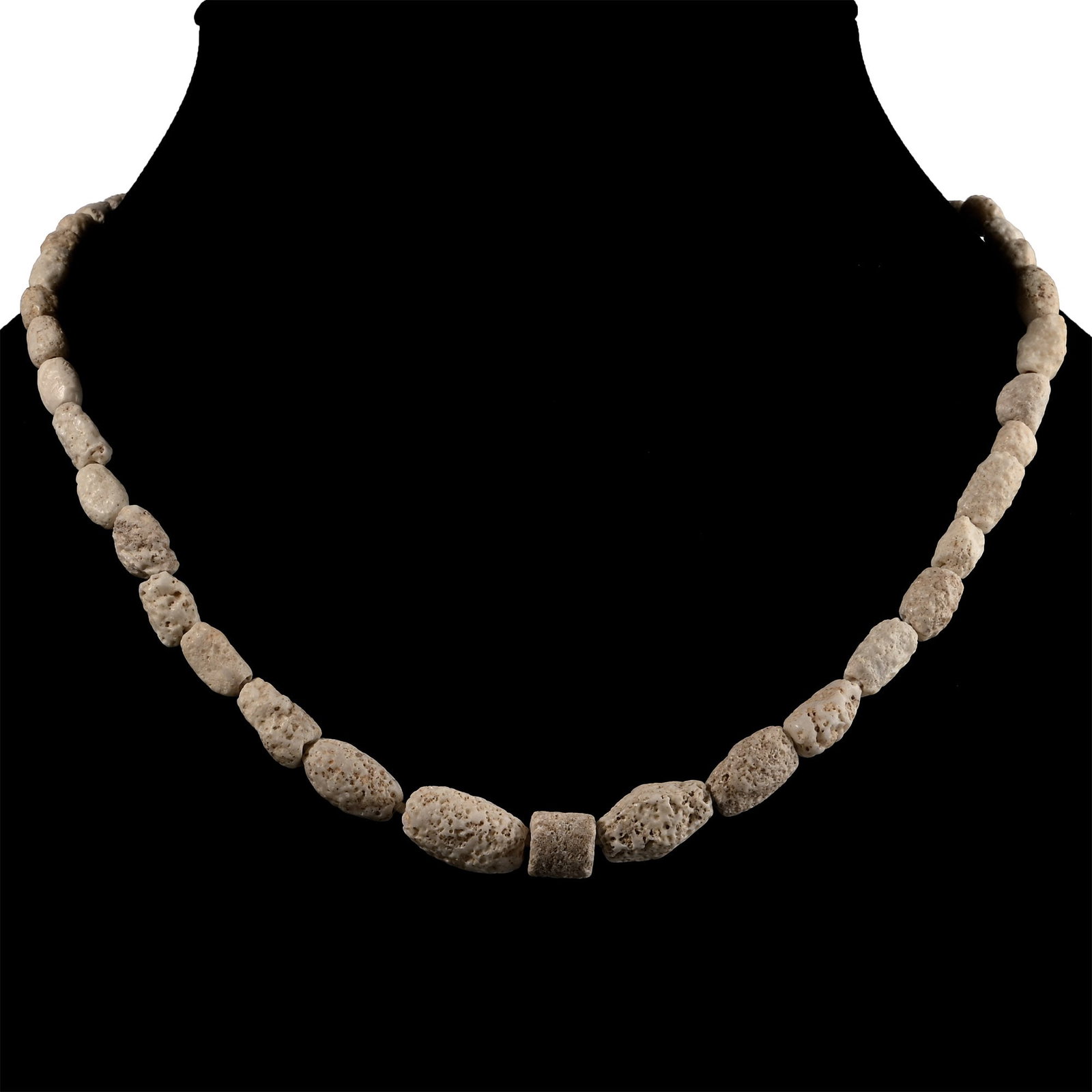 Western Asiatic Glass and Other Bead Necklace String: 1st millennium B.C. and later. Graduated group of cream-coloured beads; restrung. 21 grams, 37.5 cm (14 3/4 in.). [No Reserve] Acquired in the 1990s. Ex London, UK, collection. TimeLine Auctions follo