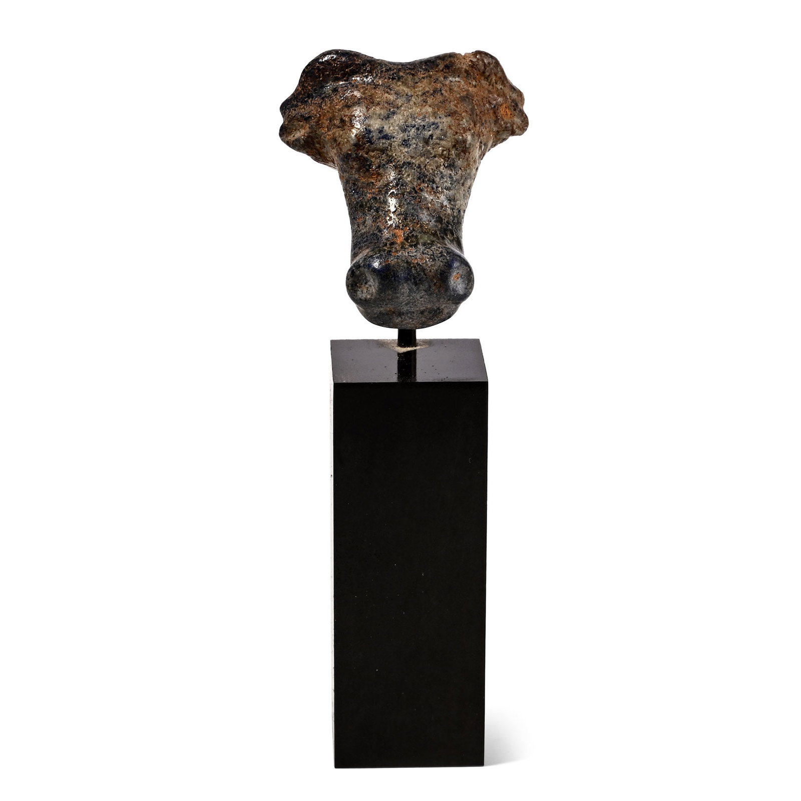 Western Asiatic Lapis Lazuli Head of a Bull: 1st millennium B.C. Carved in the round with indented nostrils and mouth, domed eyes, horns spread above the ears; mounted on a custom-made stand. 170 grams total, bull: 34 mm, 89 mm high including st