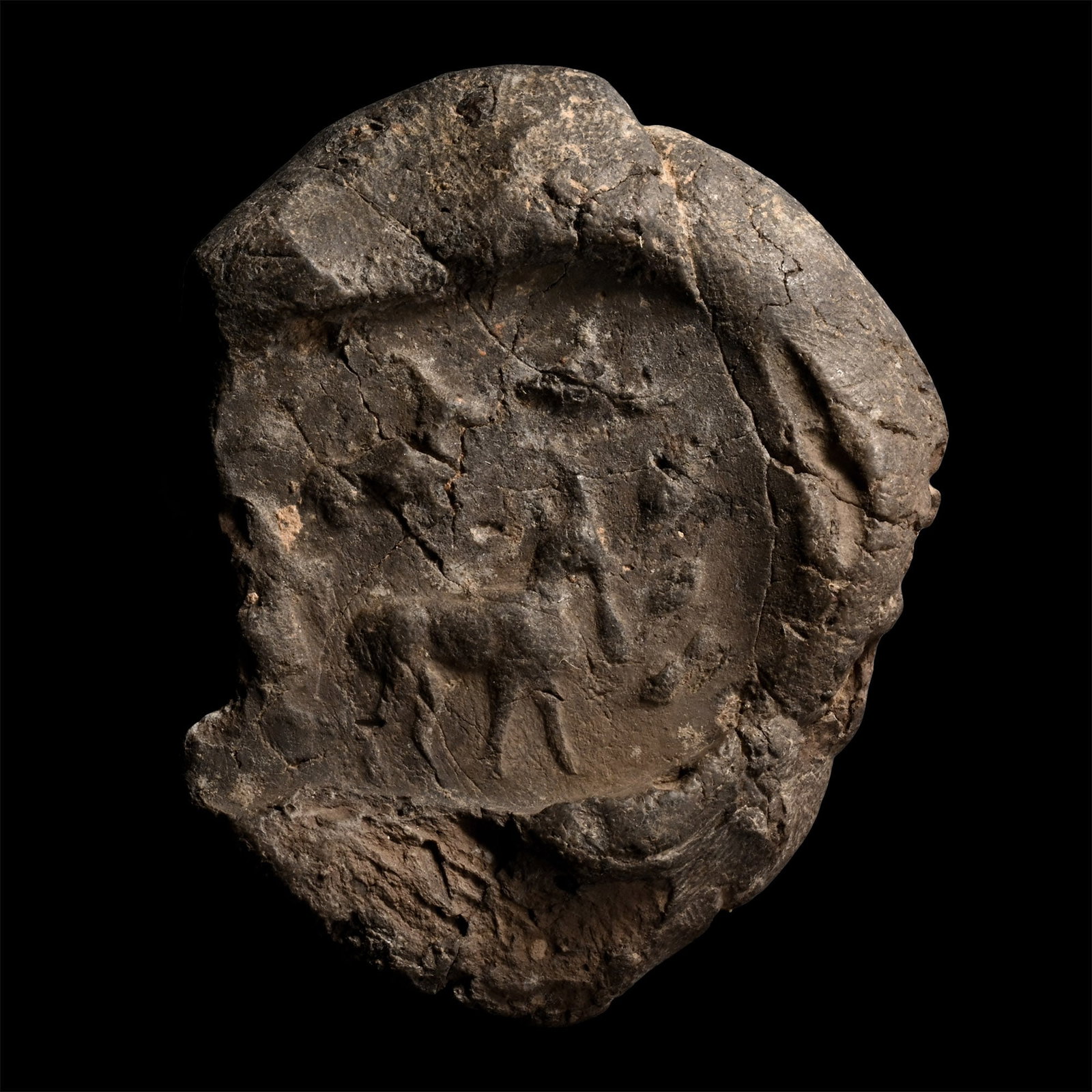 Large Sasanian Terracotta Bulla with Animals: Circa 400-600 A.D. A large fragment of a bulla showing a standing ibex and other animals. The bulla presents similarity in style with a Sassanian bulla in the Saeedi Collection, see Gyselen, R., Sasan