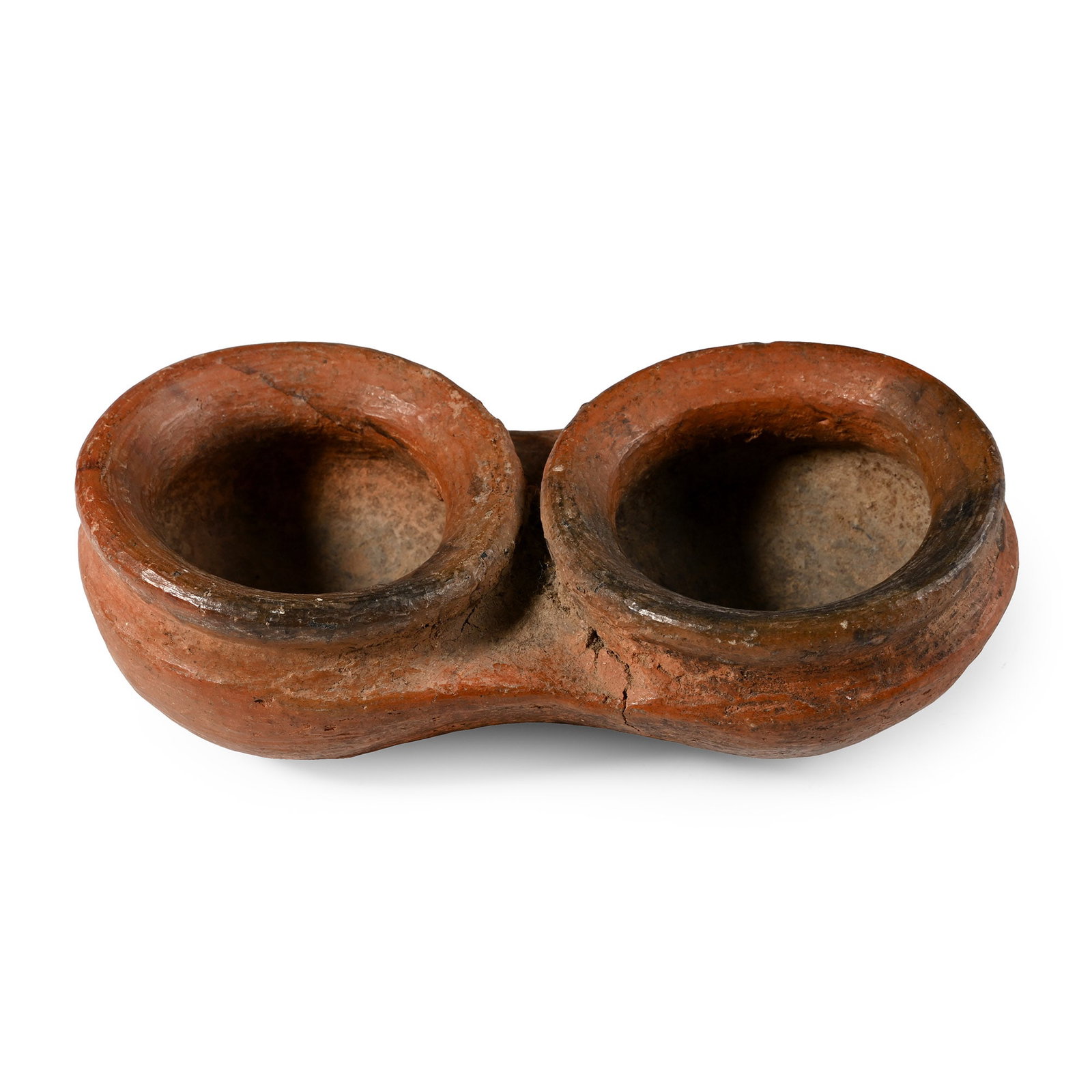 Western Asiatic Terracotta Double-Well Oil Lamp: Bronze Age, circa 2nd millennium B.C. Comprising two low circular wells with thick everted rims. 213 grams, 13.7 cm (5 3/8 in.). [No Reserve] From the collection of a Cambridge, UK, gentleman, by dire