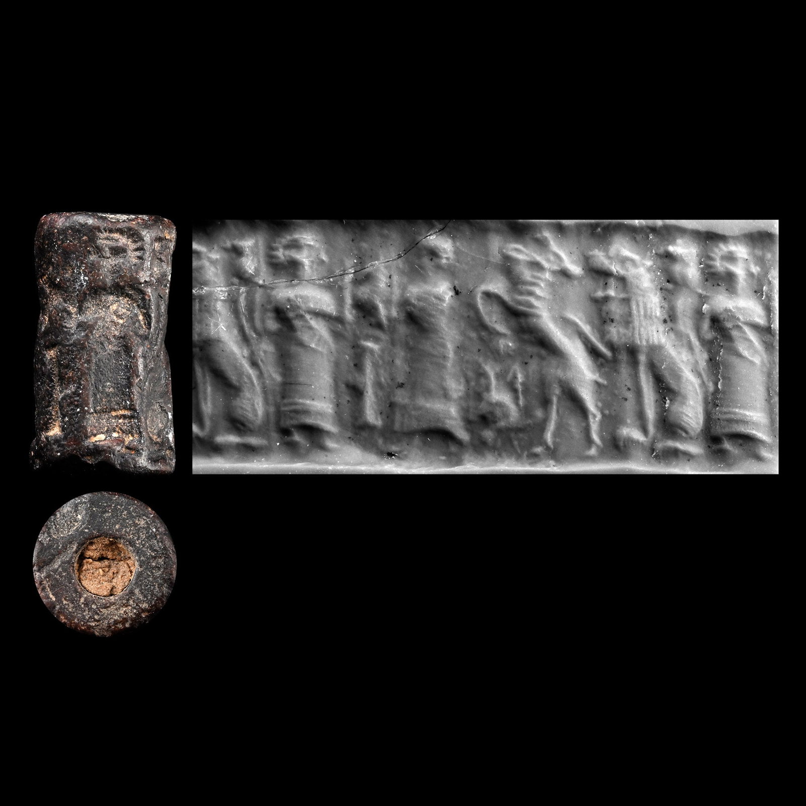 Western Asiatic Haematite Cylinder Seal with Processional Scene: 2nd-1st millennium B.C. Featuring a processional scene comprising a pair of robed figures flanking an altar, followed by zoomorphic figures, one of the robed figures raising his arm towards the altar;