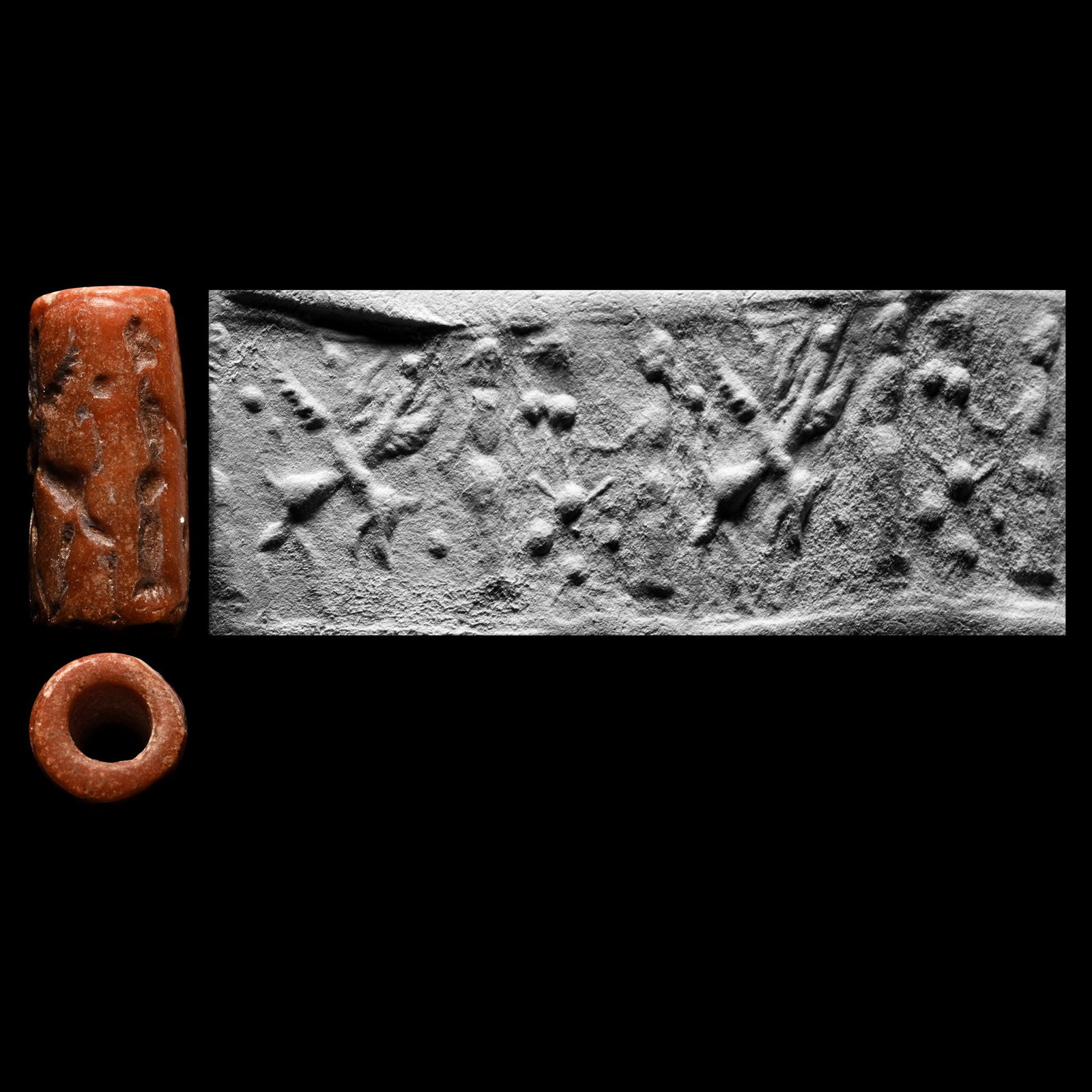 Middle Assyrian Red Coral Cylinder Seal: Circa 1350-1100 B.C. Small seal with gryphons with crossed necks, two males looking at each other with a stylised tree between them; supplied with a museum-quality impression. Cf. a similar seal in He