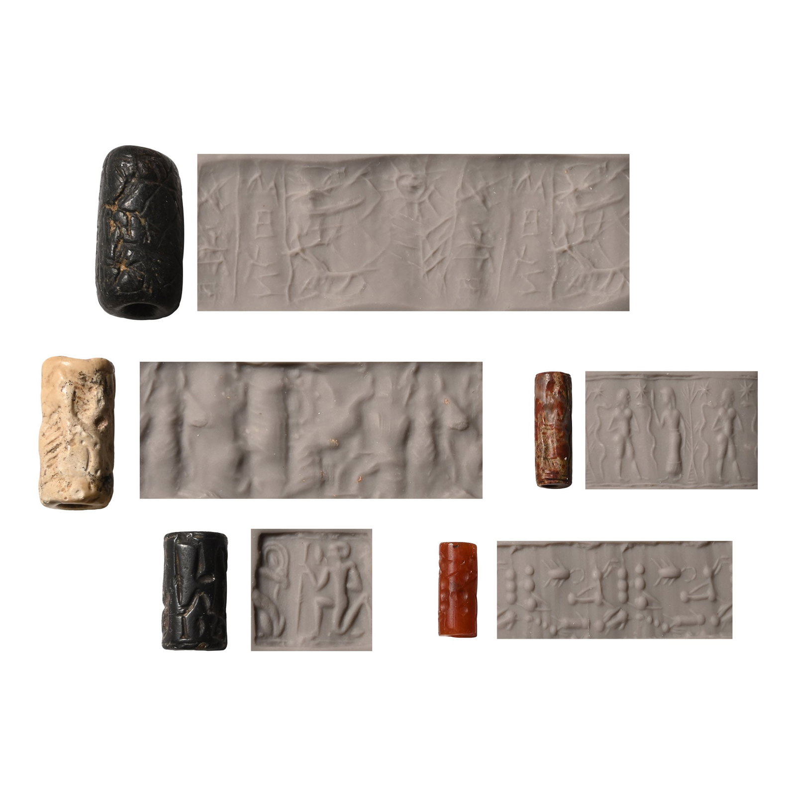 Western Asiatic Stone Cylinder Seal Group: 2nd-1st millennium B.C. Comprising: frieze with linear geometric figures, two columns of cuneiform text; drilled images of scorpions and other zoomorphs; leaping ibexes in profile and vertical fish; n