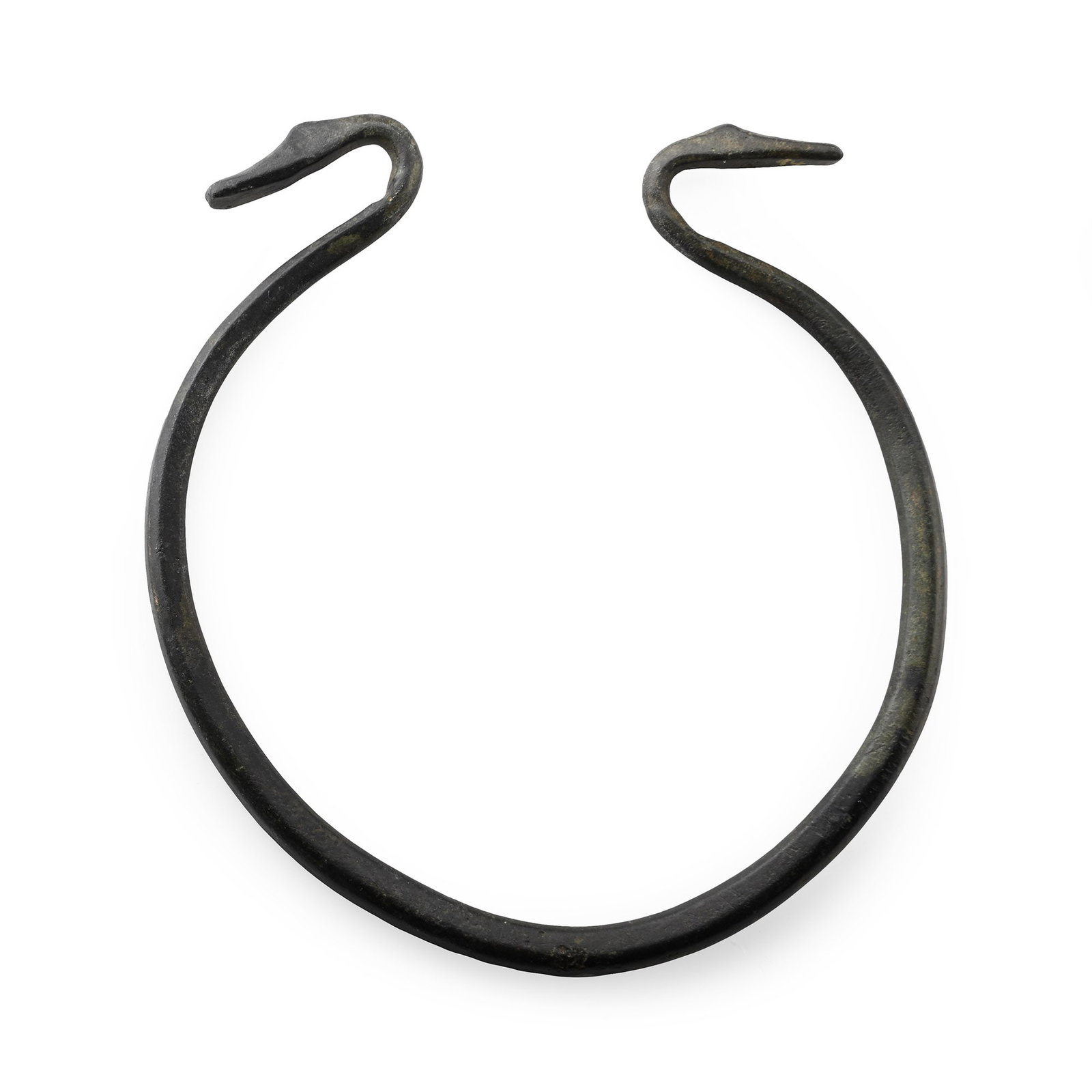 Celtic Bronze Bracelet with Bird Finials: Iron Age, circa 3rd century A.D. Penannular bracelet with two recurving finials formed as bird heads. 38.2 grams, 93 mm (3 5/8 in.). From a Wiltshire, UK, collection, 1990s. TimeLine Auctions follows 
