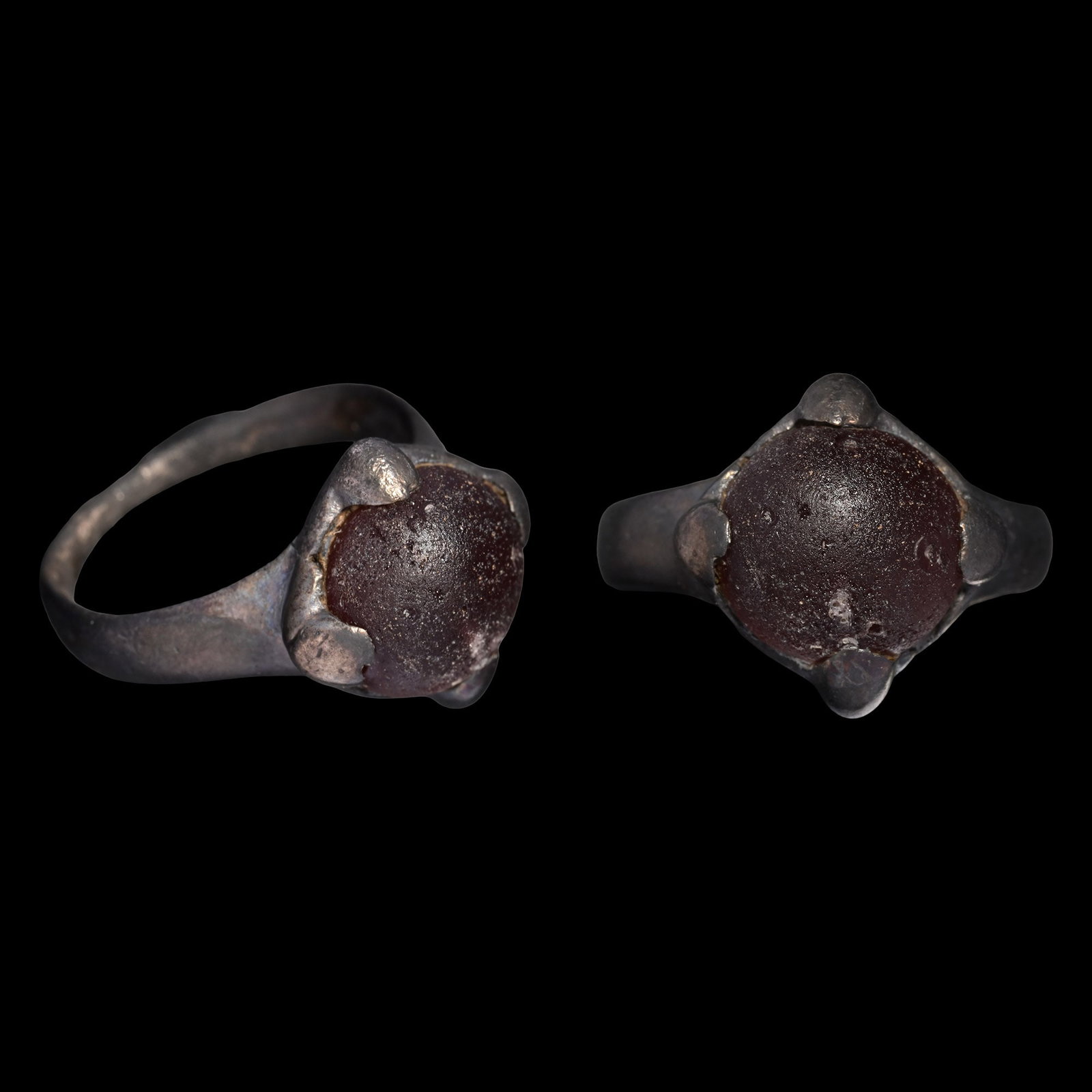 Viking Age Silver Ring with Cabochon: Circa 9th-11th century A.D. The hoop expanding towards the shoulders, set with a glass cabochon secured with four claws. 5.11 grams, 26.59 mm overall, 18.58 x 17.59 mm internal diameter (approximate s