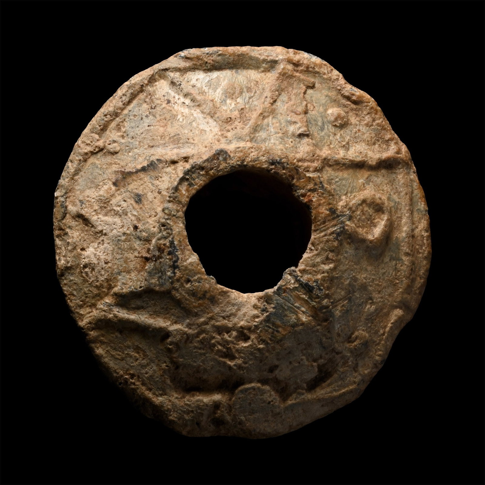 Post Saxon Decorated Lead Spindle Whorl with Runic Letter: Circa 1200 A.D. Biconical in form, with flat top and bottom surfaces, central perforation measuring 9.2 mm; both surfaces decorated with raised motifs including a non-standard rune shape (but similar 