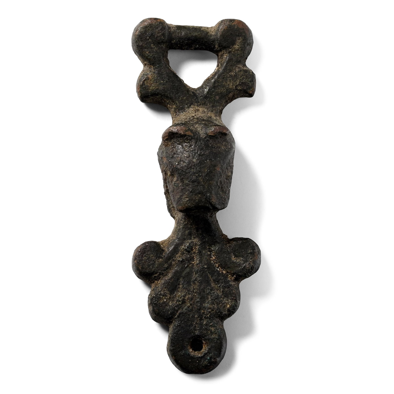 Anglo-Scandinavian Viking Bronze Harness Mount with Beast-Head: England, 11th century A.D. Comprising a raised beat-head modelled in the half-round beneath a triangular void with scrolled shoulders, open mouth with Winchester-style scrolled tendrils and pierced at
