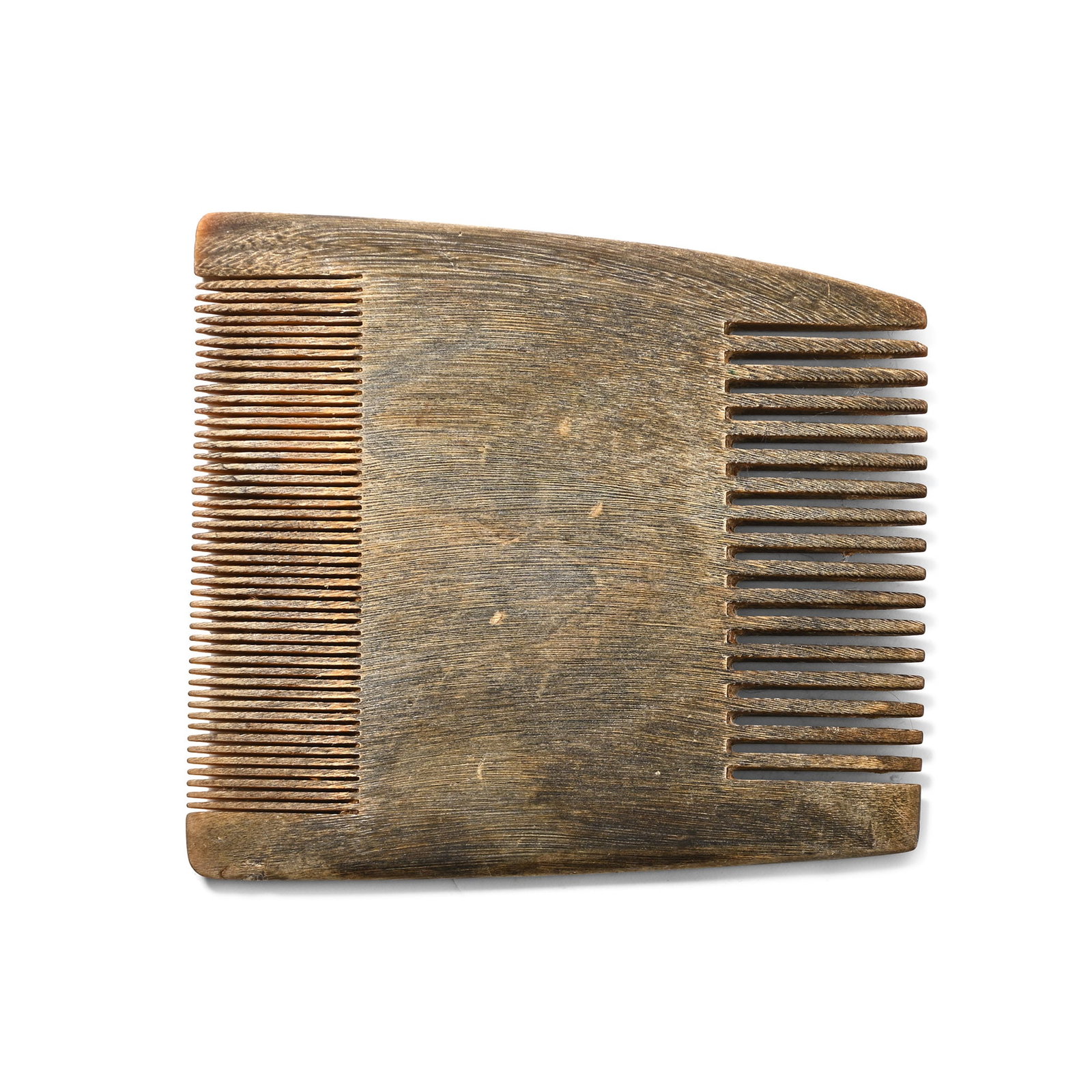 Migration Period Horn Comb: Circa 6th-8th century A.D. Trapezoidal type with saw-cut teeth to each long edge, one group coarse and the other fine. 14.95 grams, 71 mm (2 3/4 in.). Ex German art market, 2000s. Acquired from an EU 