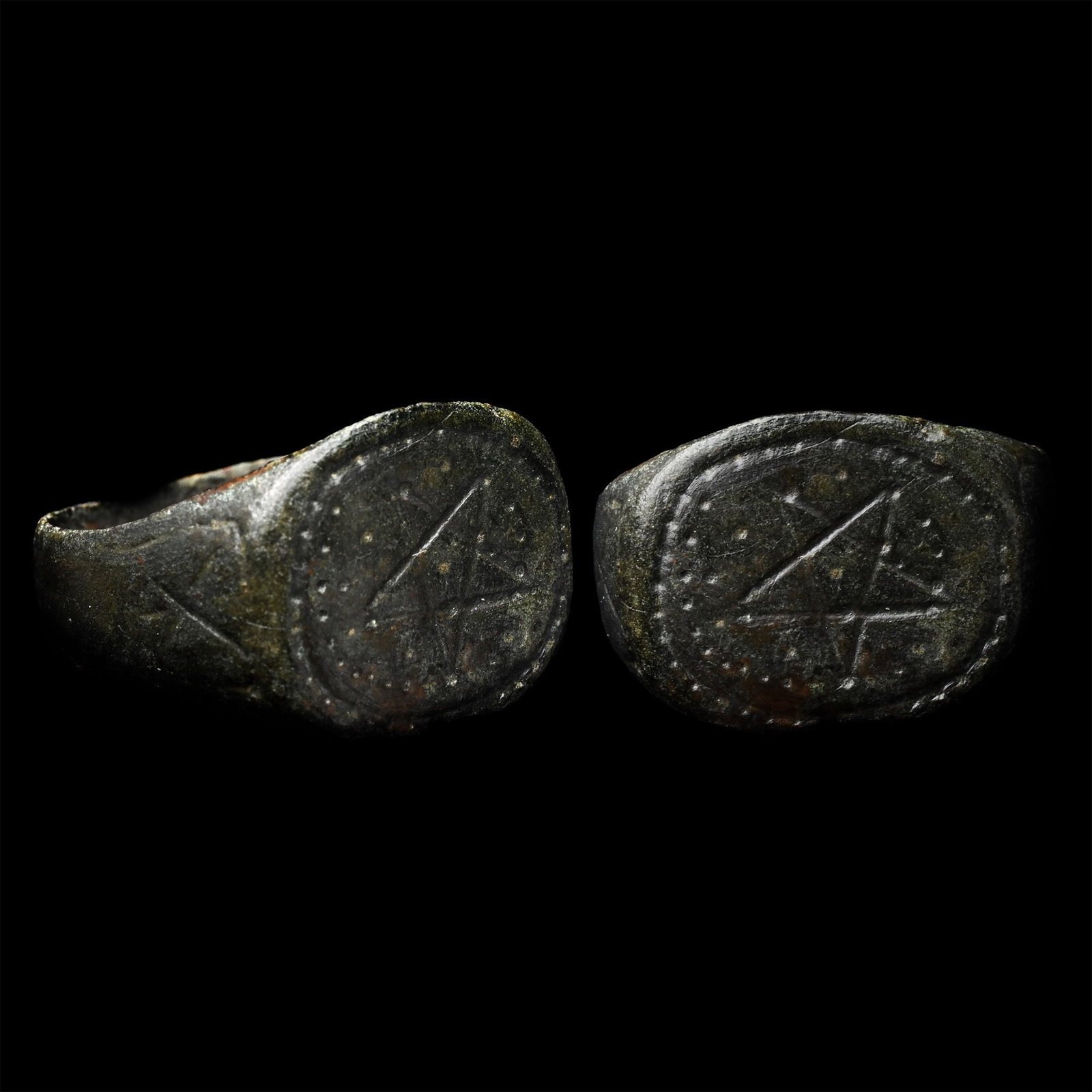 Medieval Ring with Pentagram: 12th-14th century A.D. With a wide hoop and an X-motif on each shoulder, oval bezel with a pentagram within pelletted border. 6.26 grams, 21.40 mm overall, 18.99 x 19.16 mm internal diameter (approxim