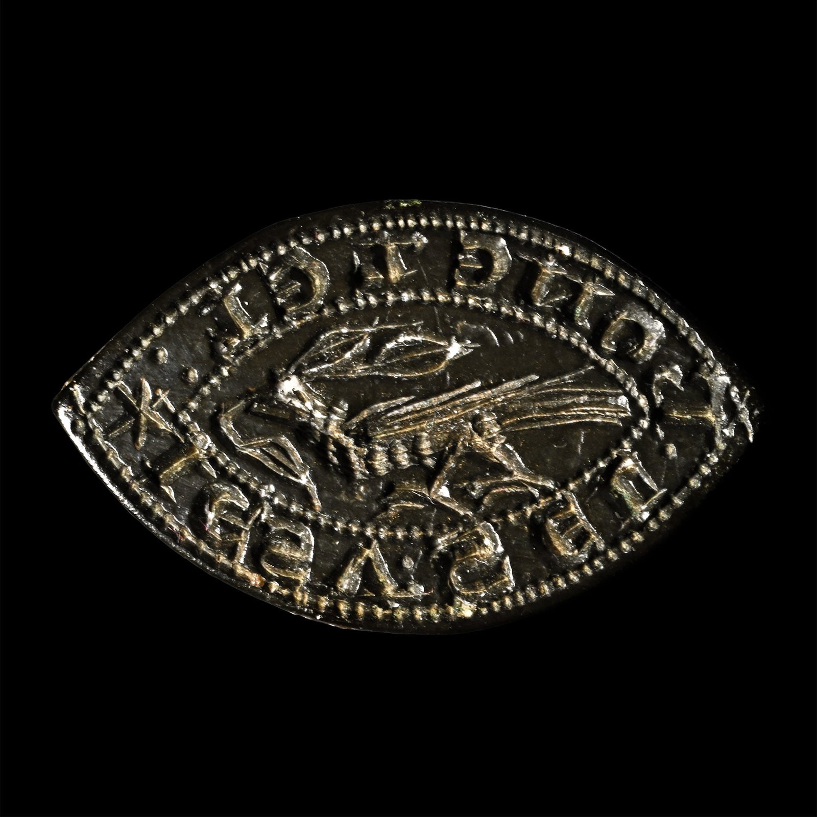 Medieval Bronze Seal with Large Bird Holding a Branch: 14th century A.D. Vesica-shaped with a loop on the reverse, a bird holding a branch at the centre, inscription surrounding 'IESV: SEL BON E LEL', translating as ?I am a seal, good and loyal?. 5.88 gra