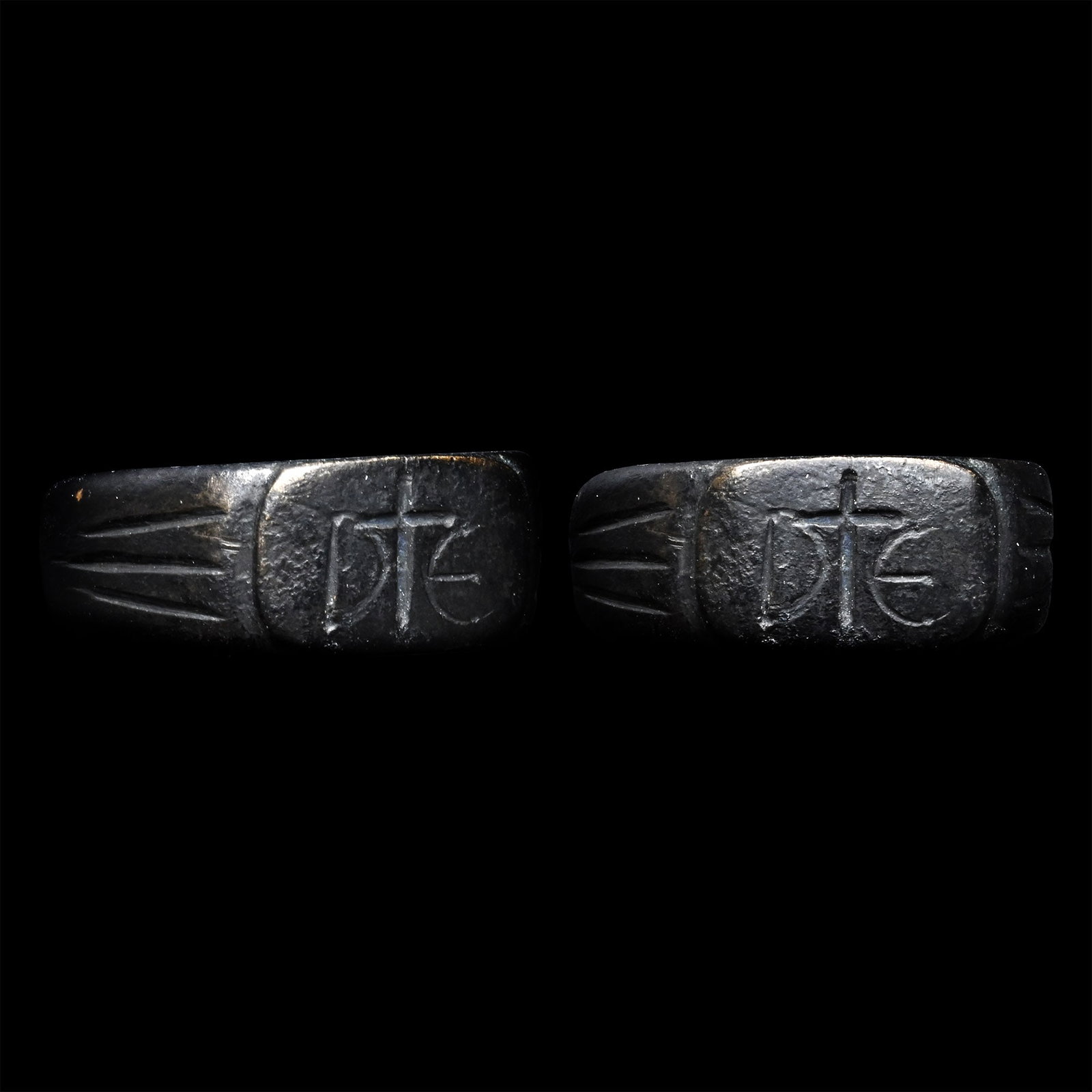 Tudor Period Ring with DE and Cross: Circa 16th century A.D. Substantial ring with fluted shoulders, a rectangular bezel with a central cross flanked by letters D and E. 11.03 grams, 26.65 mm overall, 20.86 x 22.20 mm internal diameter (