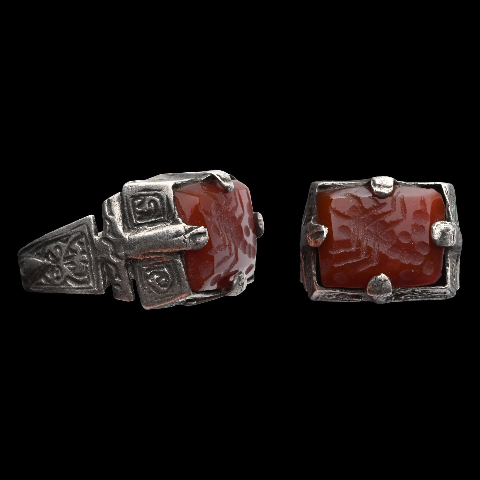Bedouin Silver-Coloured Metal Ring with Gemstone: 20th century A.D. Flat-section hoop with raised bosses beneath the decorative panels on the shoulders, a rectangular bezel set with an agate gemstone with a scorpion motif. 8.43 grams, 29.22 mm overal