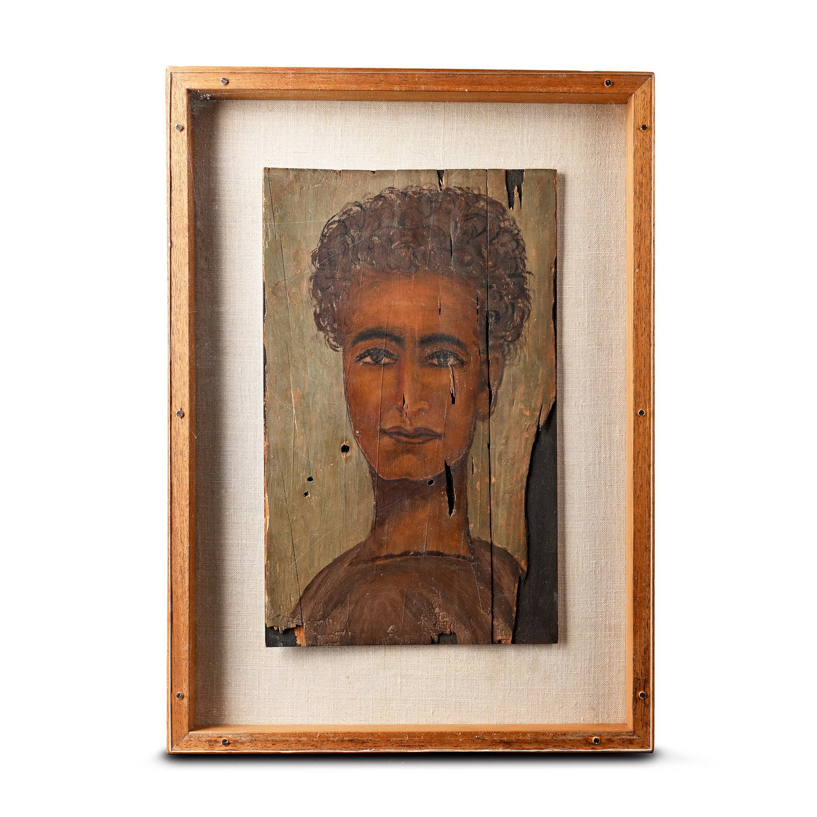 Romano-Egyptian Style Fayum Portrait of a Woman: 20th century A.D. Portrait of a young woman, her head turned slightly to the right, with an oval face, thin almond-shaped eyes, and a large mouth with full lips; her curly hair arranged above her fore