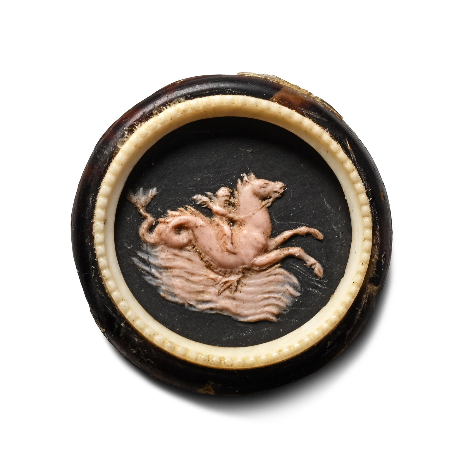 Post Medieval Cameo of Eros Riding a Hippocampus: 18th century A.D. Pink wax cameo depicting winged Eros on the back of a rearing hippocamp emerging from the waves, set on a black composite backing with a glass frame. 2.32 grams, 24 mm (1 in.). Acqui
