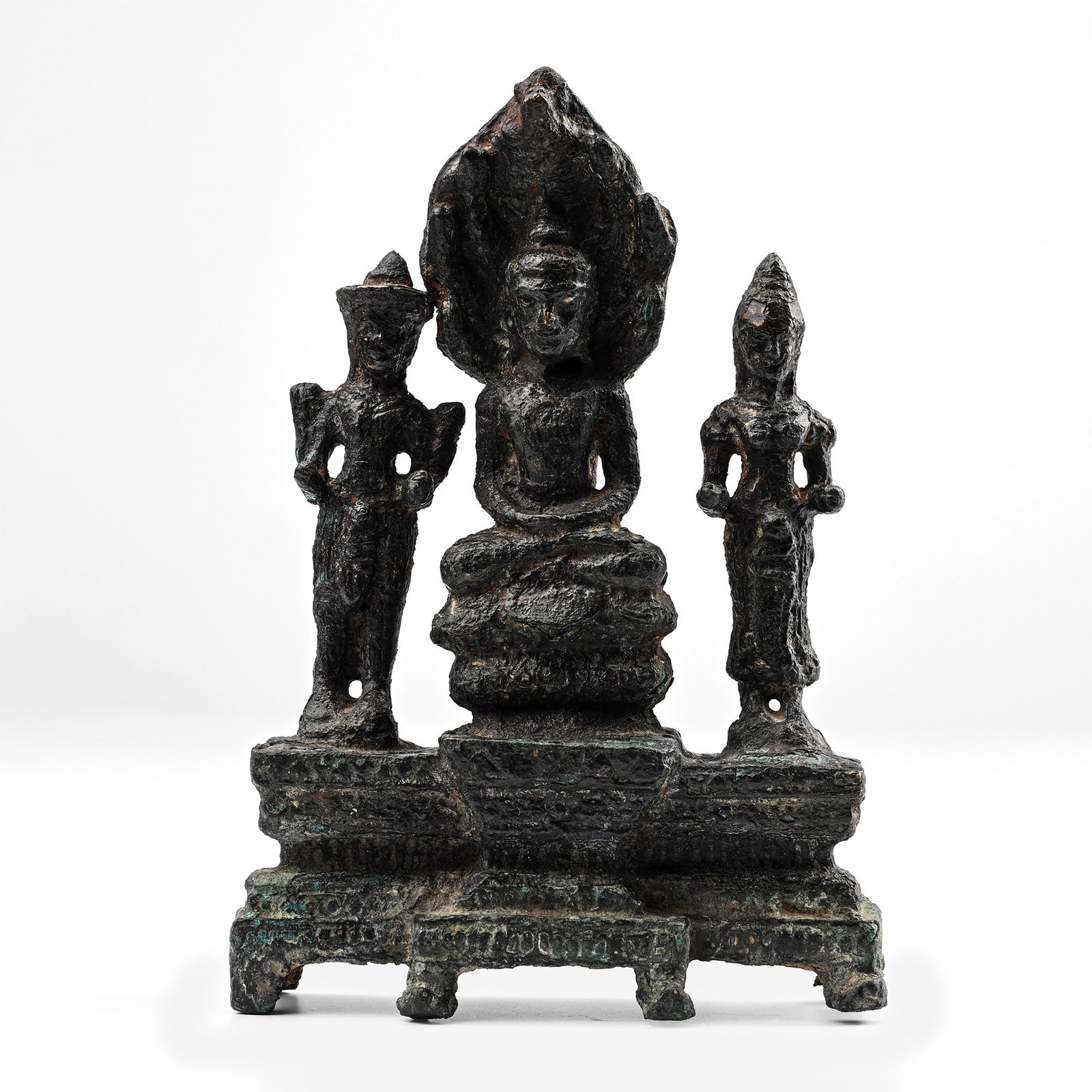 Thai or Cambodian Bronze Seated Buddha with Attendants: 13th century A.D. or later. Modelled in the round throne scene with Buddha seated protected by a canopy of seven-headed naga, flanked by standing male and female figures with arms bent to accept offer