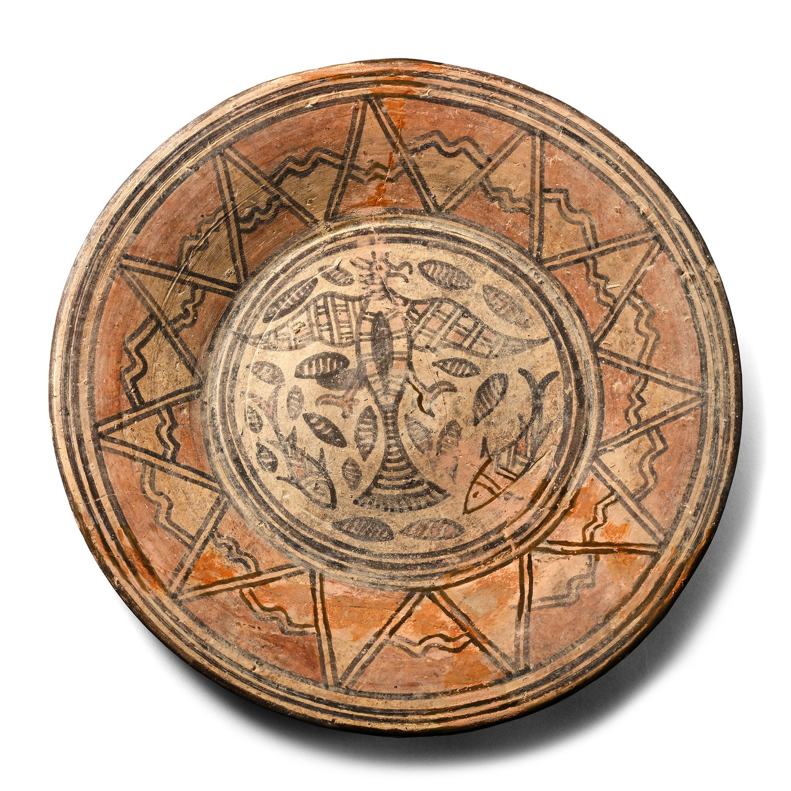Large Indus Valley Plate with Eagle and Fish: Circa 3rd-2nd millennium B.C. Shallow plate with flat base, painted geometric decoration on the inner walls, and the base with a splayed eagle surrounded by fish and other motifs. 765 grams, 25 cm wid