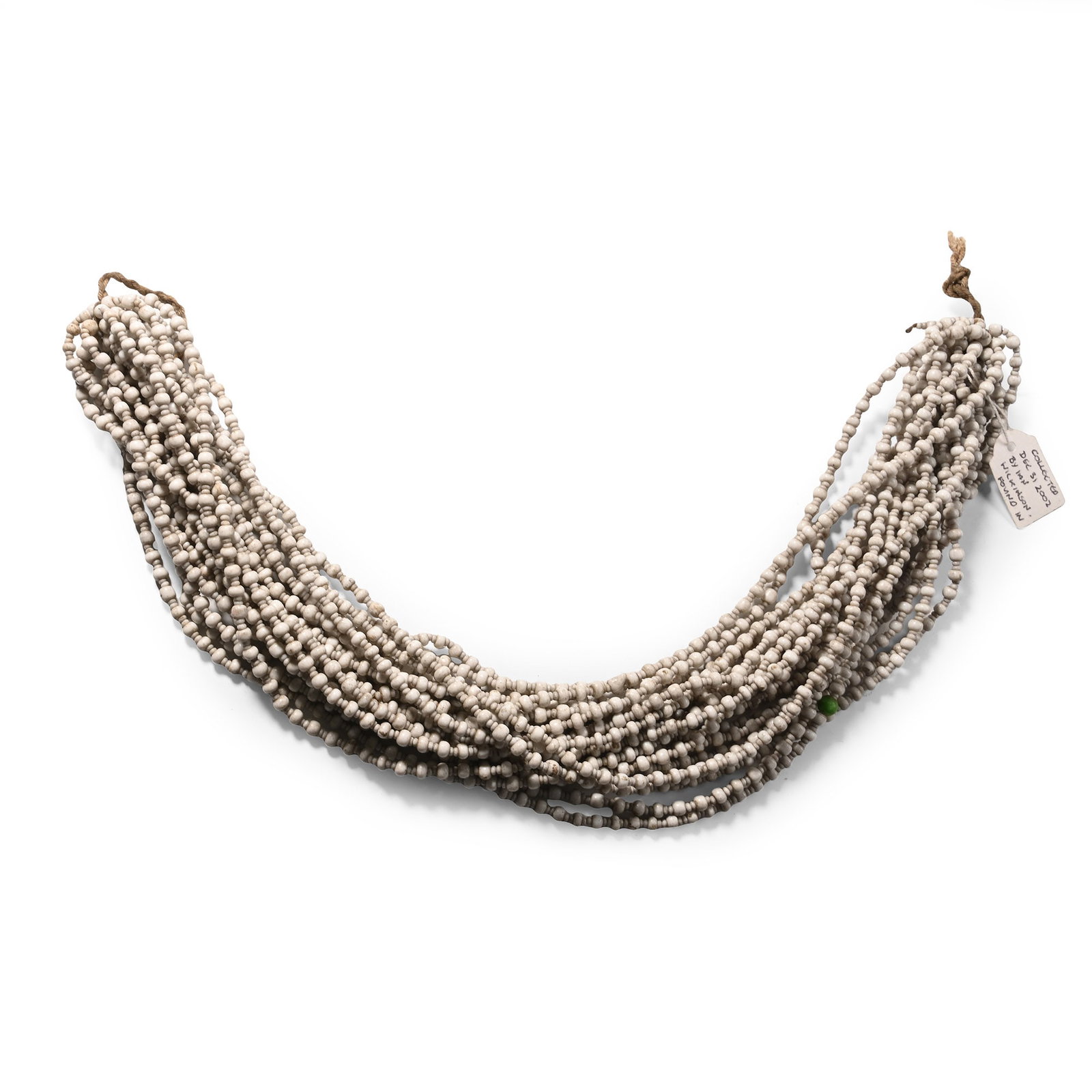 Zulu Man's Glass Bead Long Necklace: 20th century A.D. Composed of alternating small and slightly large white beads with a single green bead. 188 grams, 39 cm (15 3/8 in.). [No Reserve] From the Mbongolwani area of Kzn, Zululand, South A