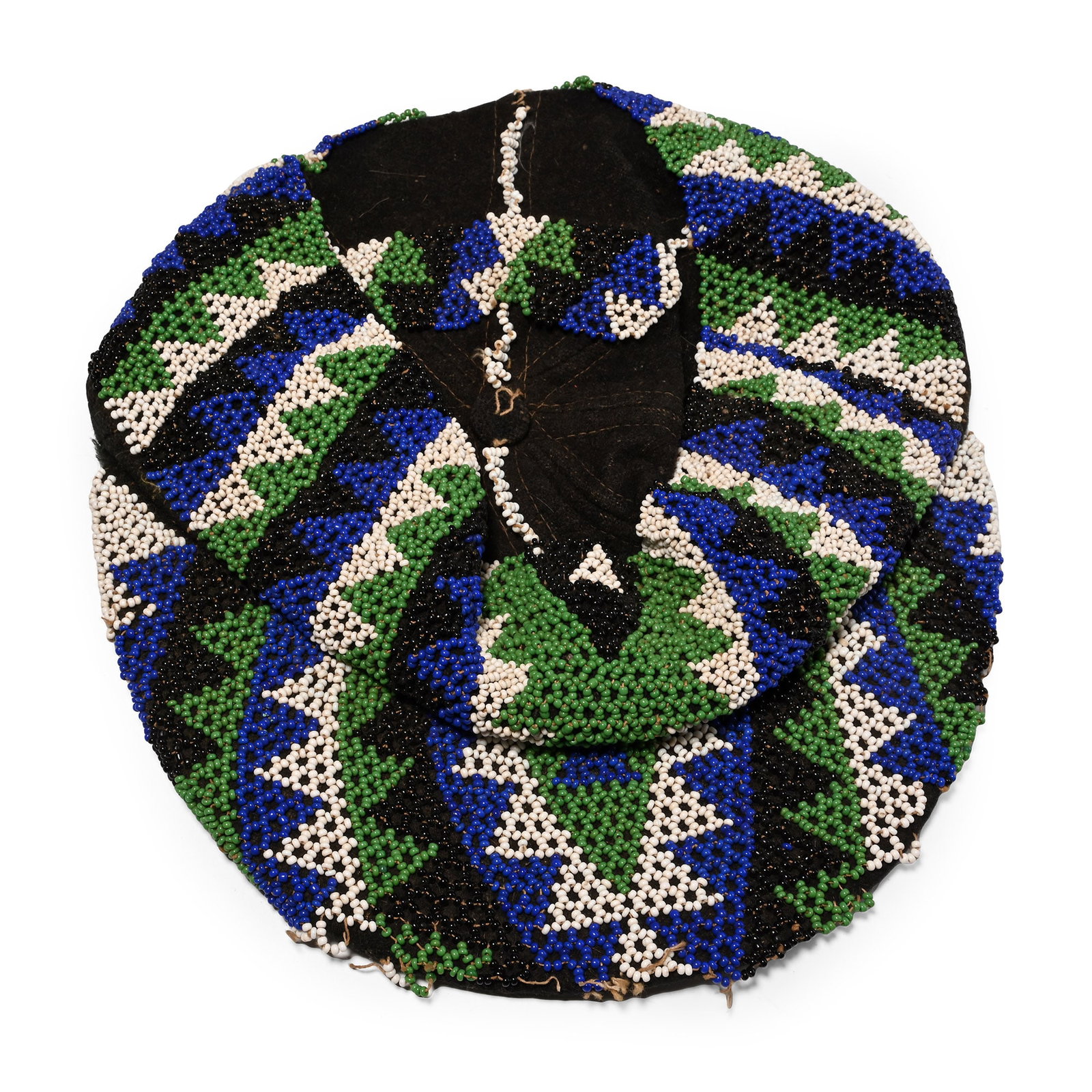 Zulu Man's Glass Bead Cap: 20th century A.D. A fabric cap extensively decorated with small blue, white, green and black beads. 285 grams, 24.5 cm (9 5/8 in.). [No Reserve] Collected in Northern Zululand, South Africa, 2001. Ian
