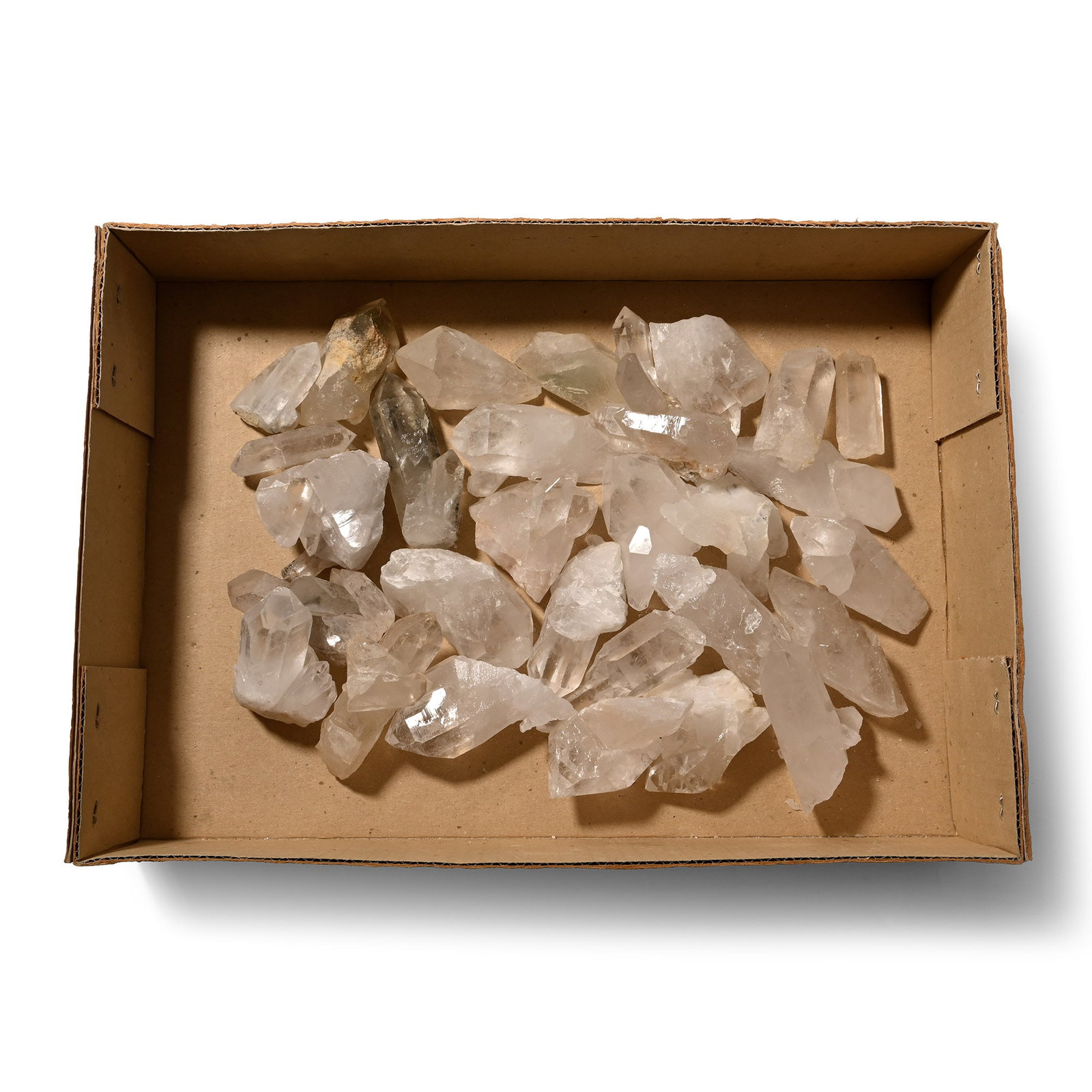 Group of Twenty Nine [29] Large Rock Crystal Quartz Specimens: Boxed group of mainly prismatic colourless specimens, some twinned and three specimens with dark dendritic inclusions. 2.93 kg total, 45-88 mm (1 3/4 - 3 1/2 in.). [29, No Reserve] From Brazil. Ex Min