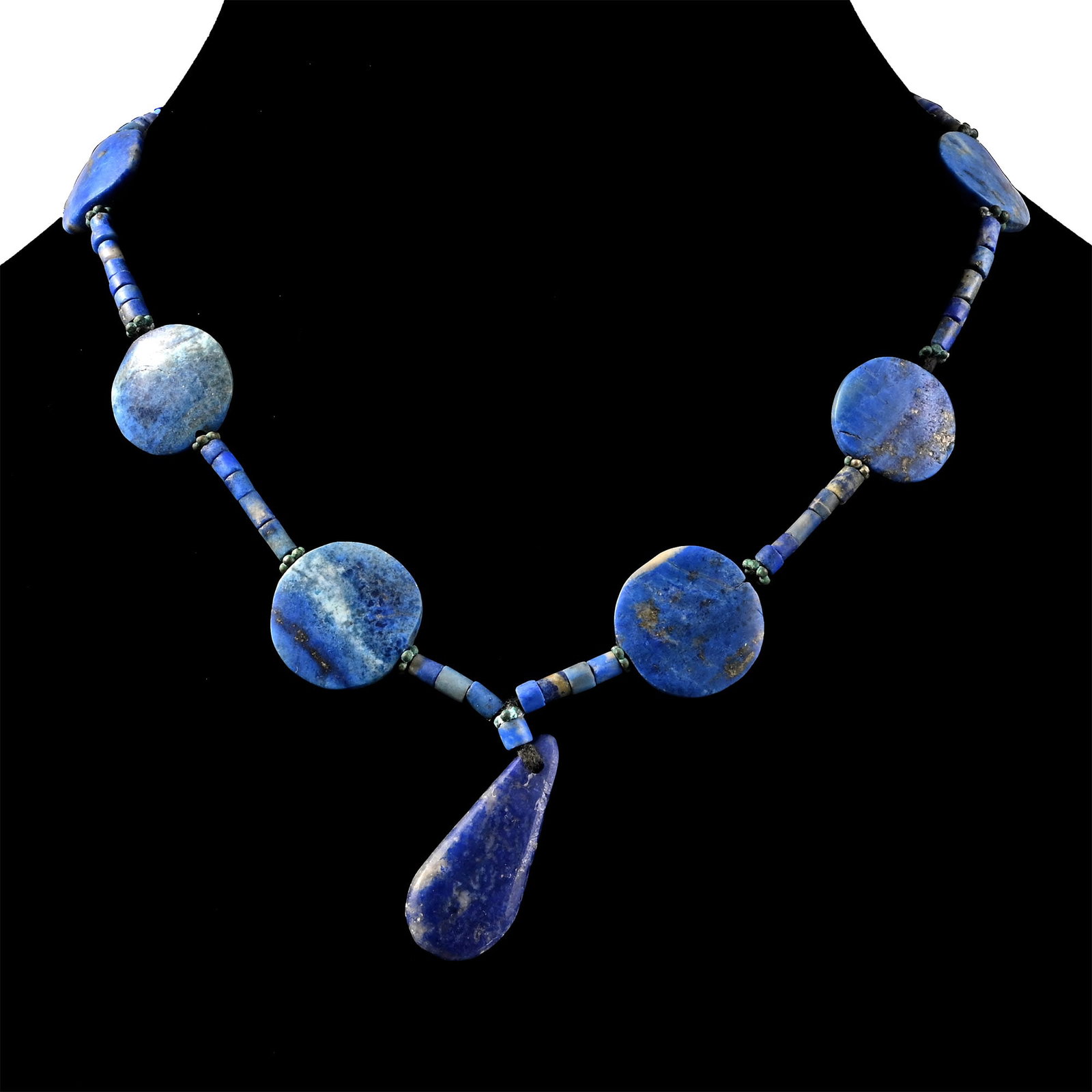 Bactrian Style Lapis Lazuli Bead Necklace String: Composed of coin-shaped and tubular beads with a teardrop-shaped pendant, restrung. 30.8 grams, 33.5 cm (13 1/4 in.). [No Reserve] Acquired in the 1990s-early 2000s. Ex London, UK, collection. TimeLin