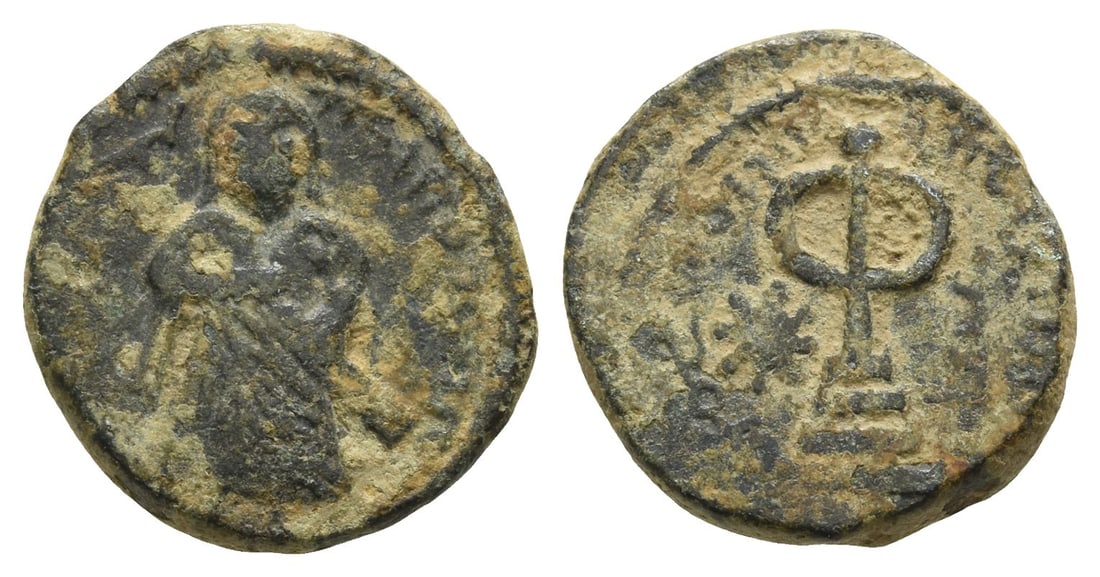 Arab-Byzantine, Umayyad Caliphate AE Fals.: Time of 'Abd al-Malik ibn Marwan, AH 65-86 (AD 685-705). Struck AH 74-80 (AD 693/4-699/700). Amman mint. 'Standing Caliph' type.. Caliph standing facing, wearing long robes, holding pommel of sword; g