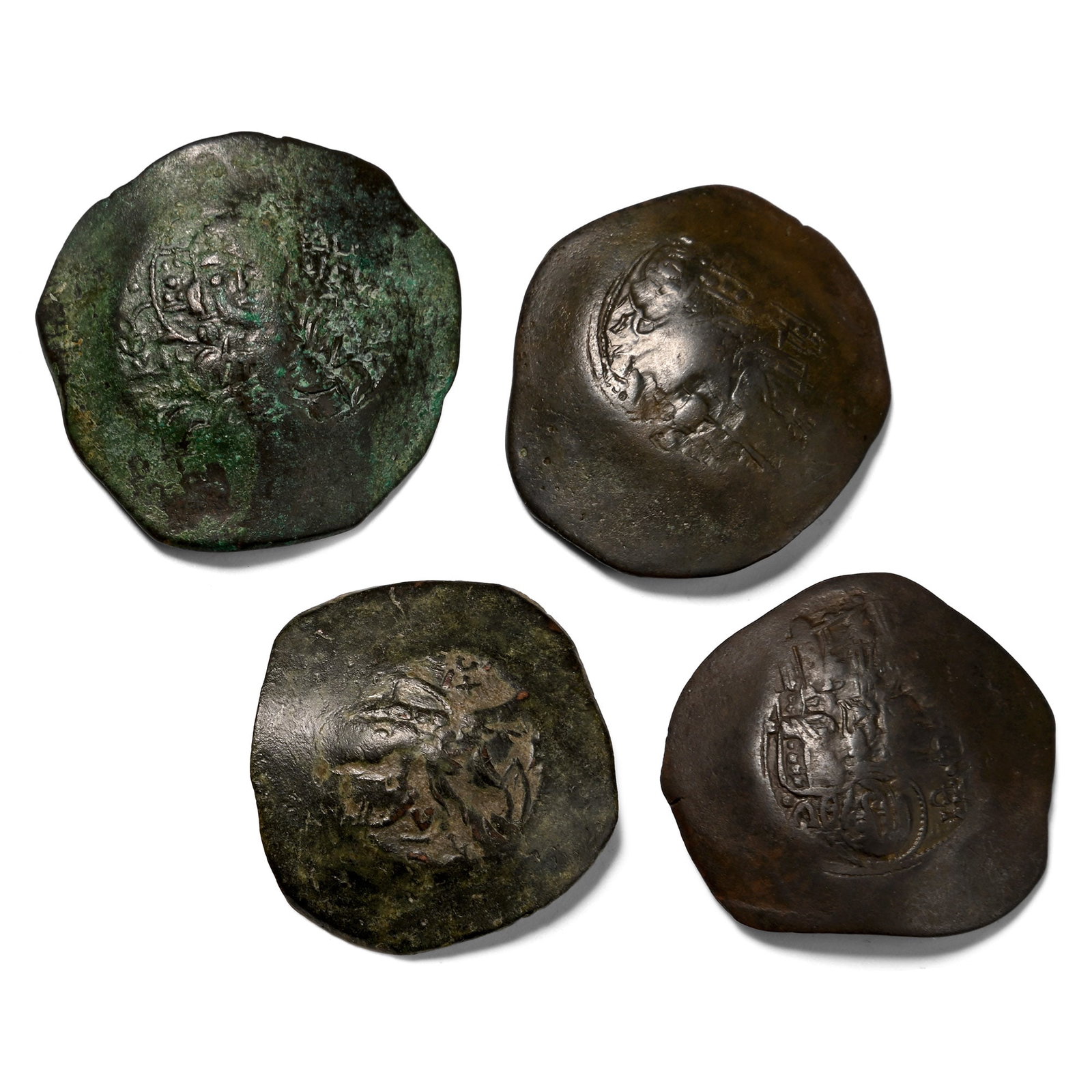 Group of Four [4] BI Byzantine Trachy Coins.: Circa 12th century A.D. Comprising: mixed emperors, issues and reverse types. 13.31gr total, 25-28mm. Condition as shown. From the collection of a Hertfordshire, UK, gentleman. Property of a West Lond