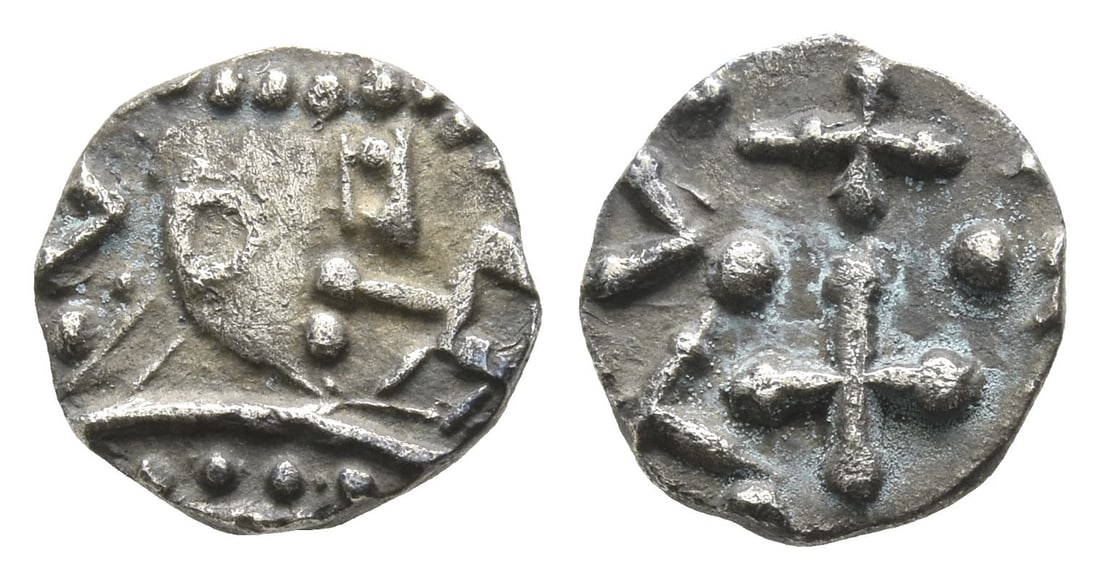 Anglo-Saxon. Continental Sceattas AR Sceat.: Circa 690-710/5. Mint in northern Frisia (prob. Wijnaldum). Struck under Radbod, King of Frisia. Possibly series D, type 2c.. Crude crowned bust to right; Runic letters to right / Cross pomm?e, pellet